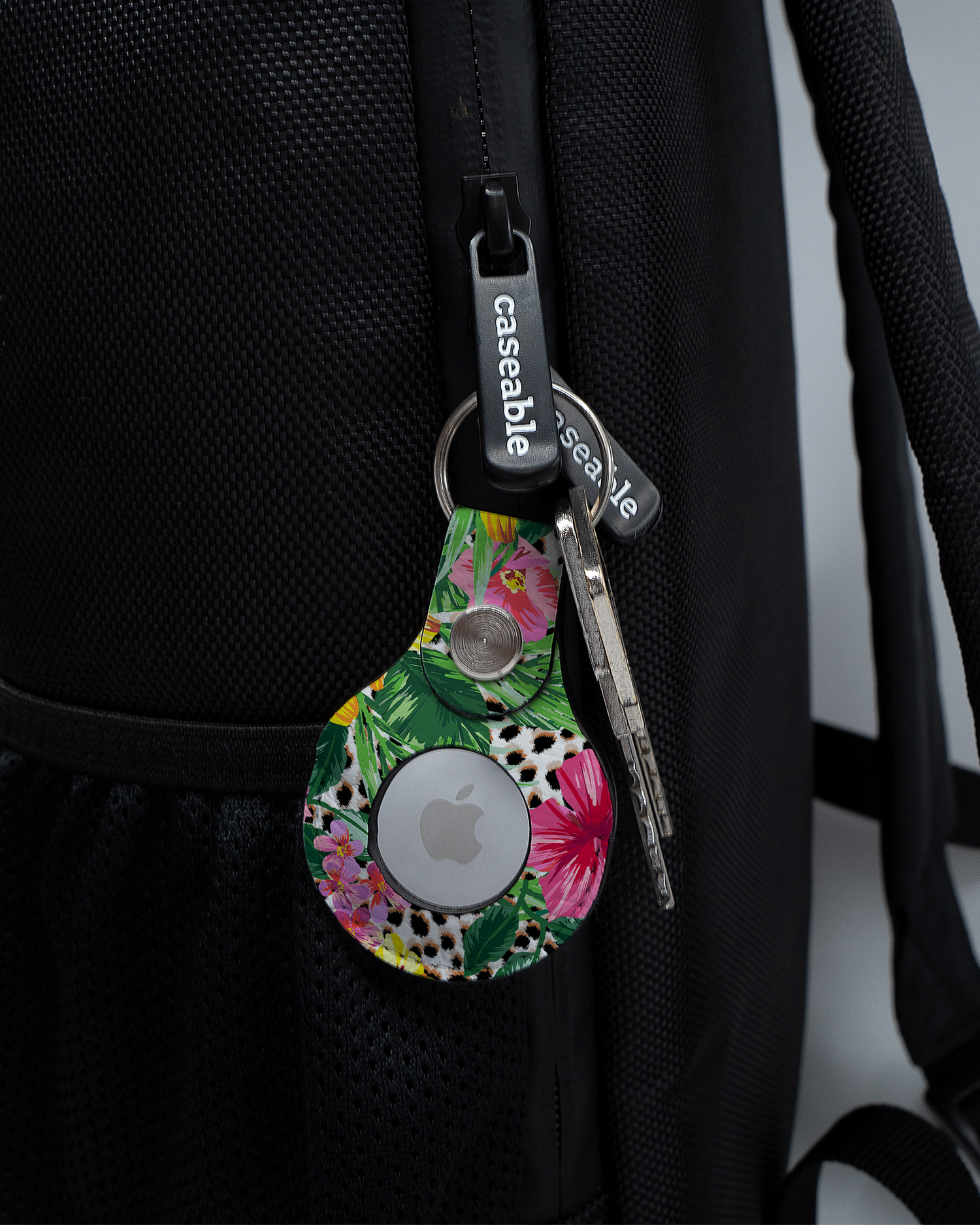 AirTag Holder with design Tropical Cheetah attached to a bag