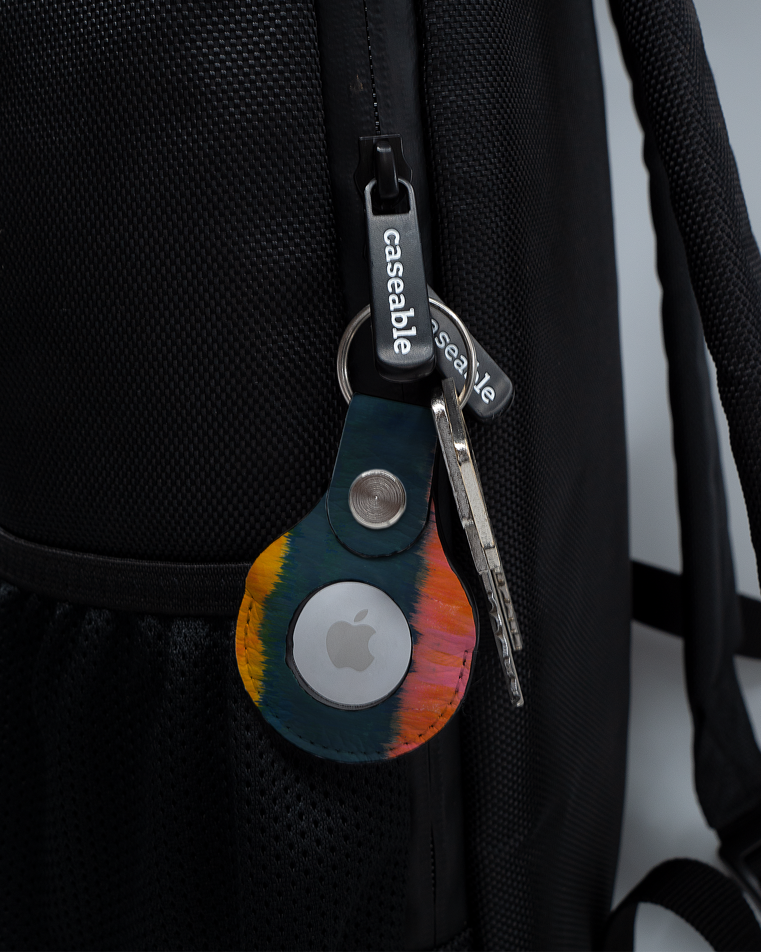 AirTag Holder with design Ombre Gradient attached to a bag