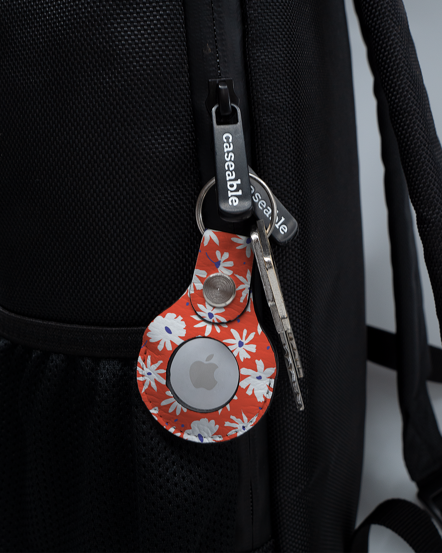 AirTag Holder with design Retro Daisy attached to a bag