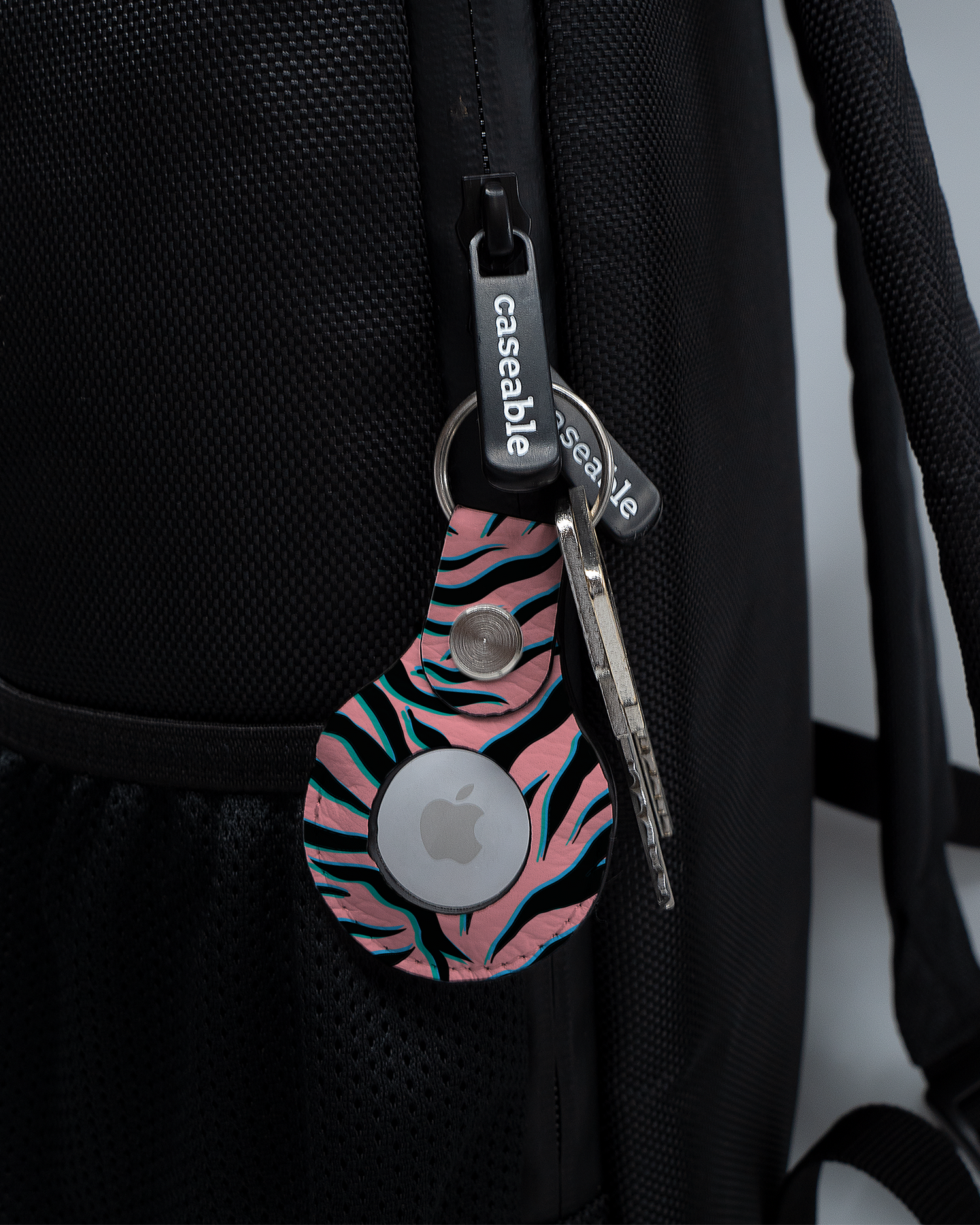 AirTag Holder with design Pink Zebra attached to a bag