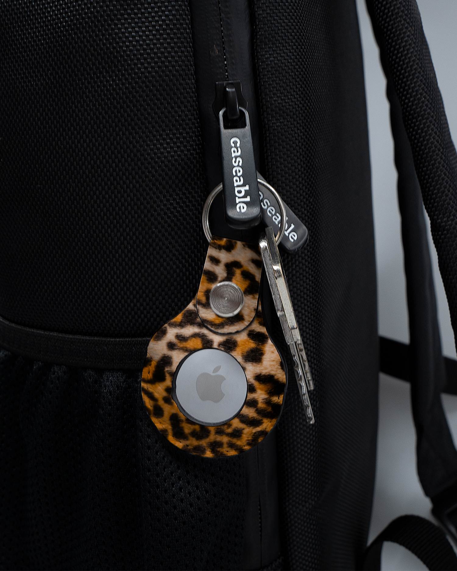 AirTag Holder with design Leopard Pattern attached to a bag