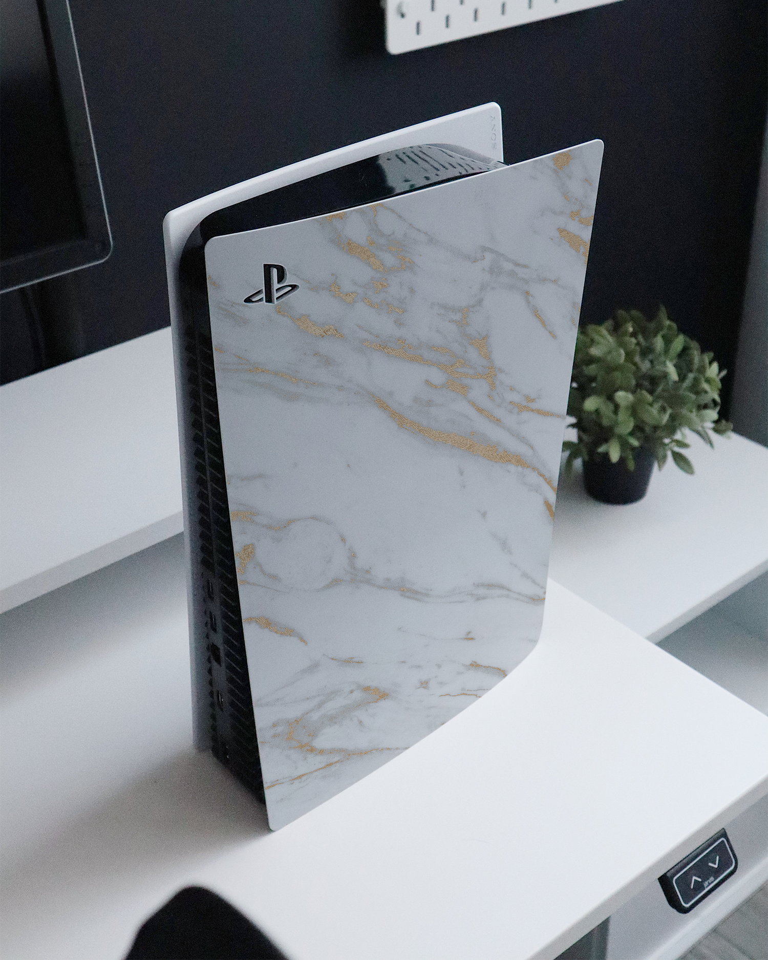 Gold Marble Elegance Console Skin for Sony PlayStation 5 Digital Edition standing on a sideboard 
