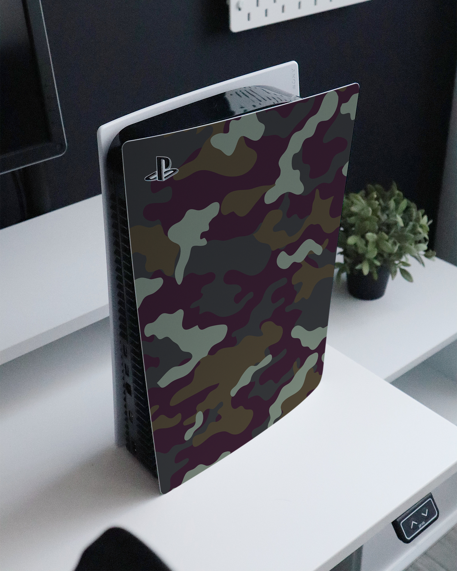Night Camo Console Skin for Sony PlayStation 5 Digital Edition standing on a sideboard 
