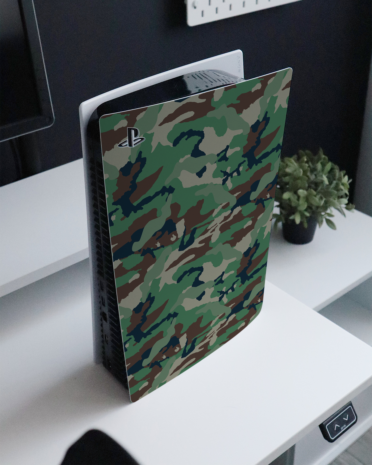Green and Brown Camo Console Skin for Sony PlayStation 5 Digital Edition standing on a sideboard 