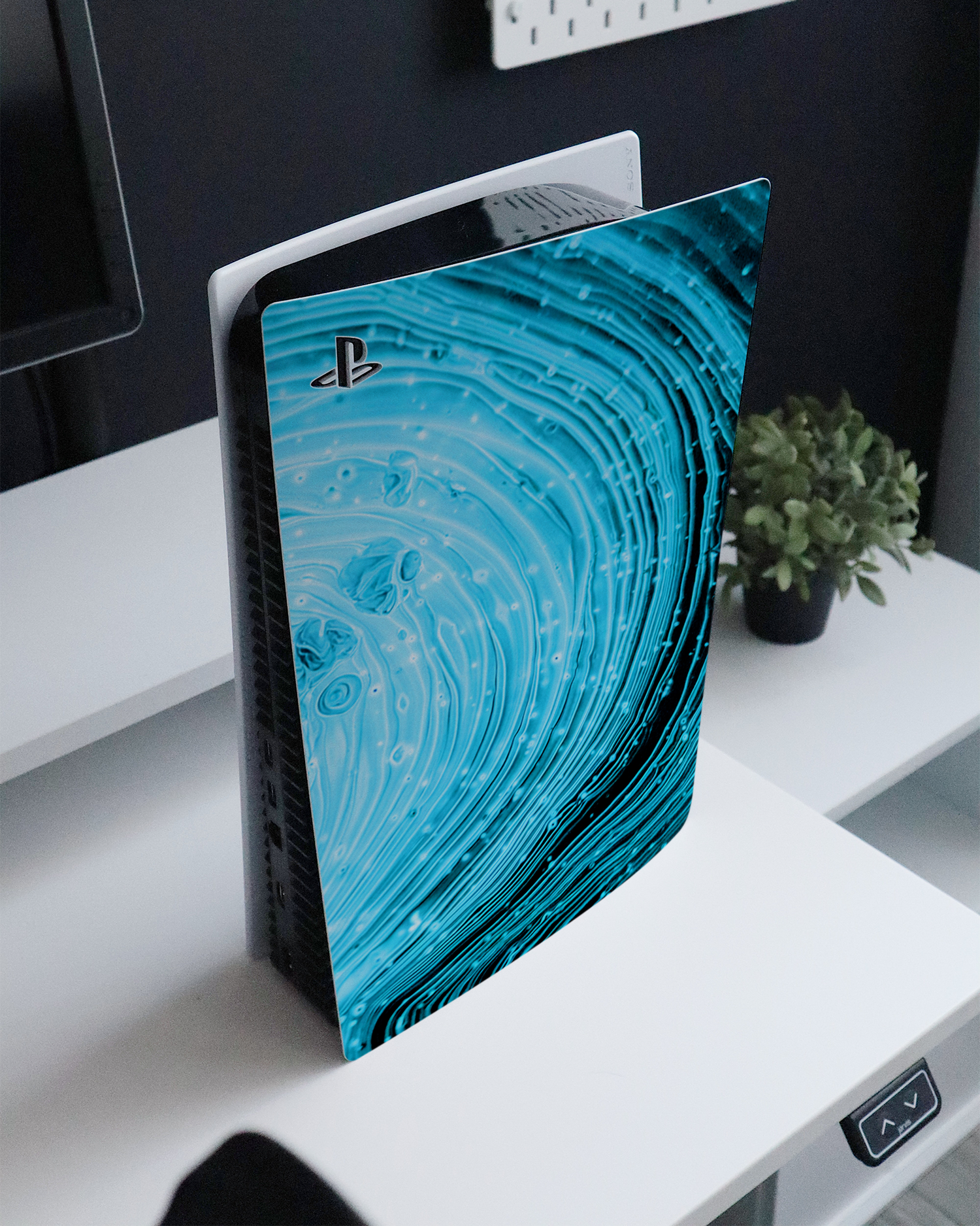 Turquoise Ripples Console Skin for Sony PlayStation 5 Digital Edition standing on a sideboard 