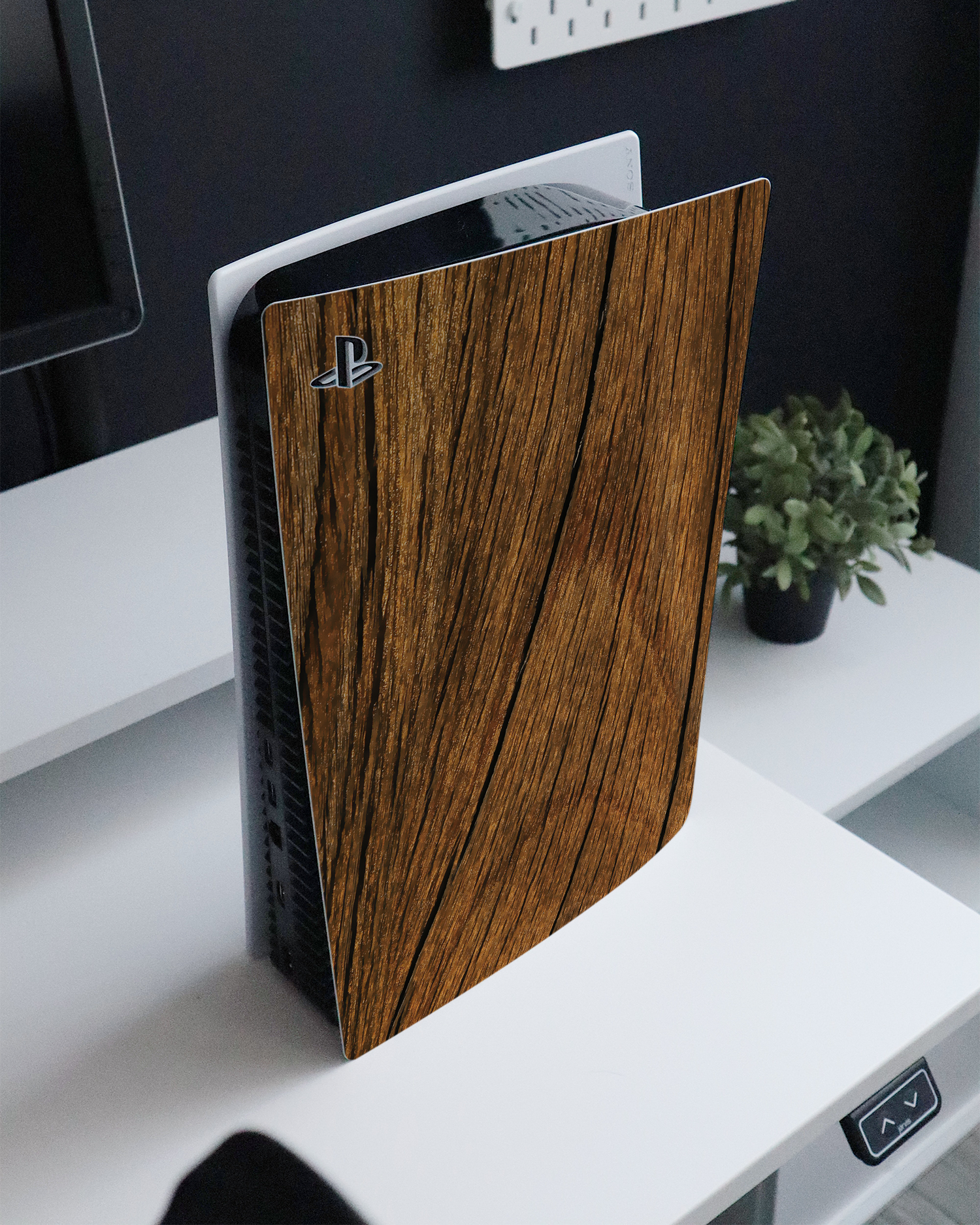 Wood Console Skin for Sony PlayStation 5 standing on a sideboard 