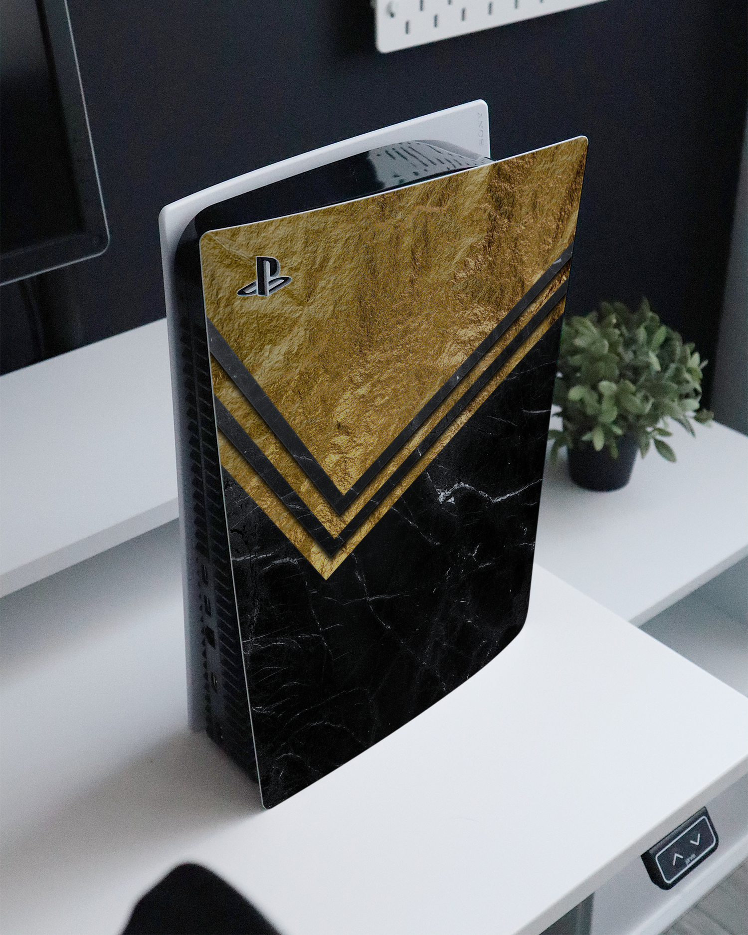 Gold Marble Console Skin for Sony PlayStation 5 standing on a sideboard 