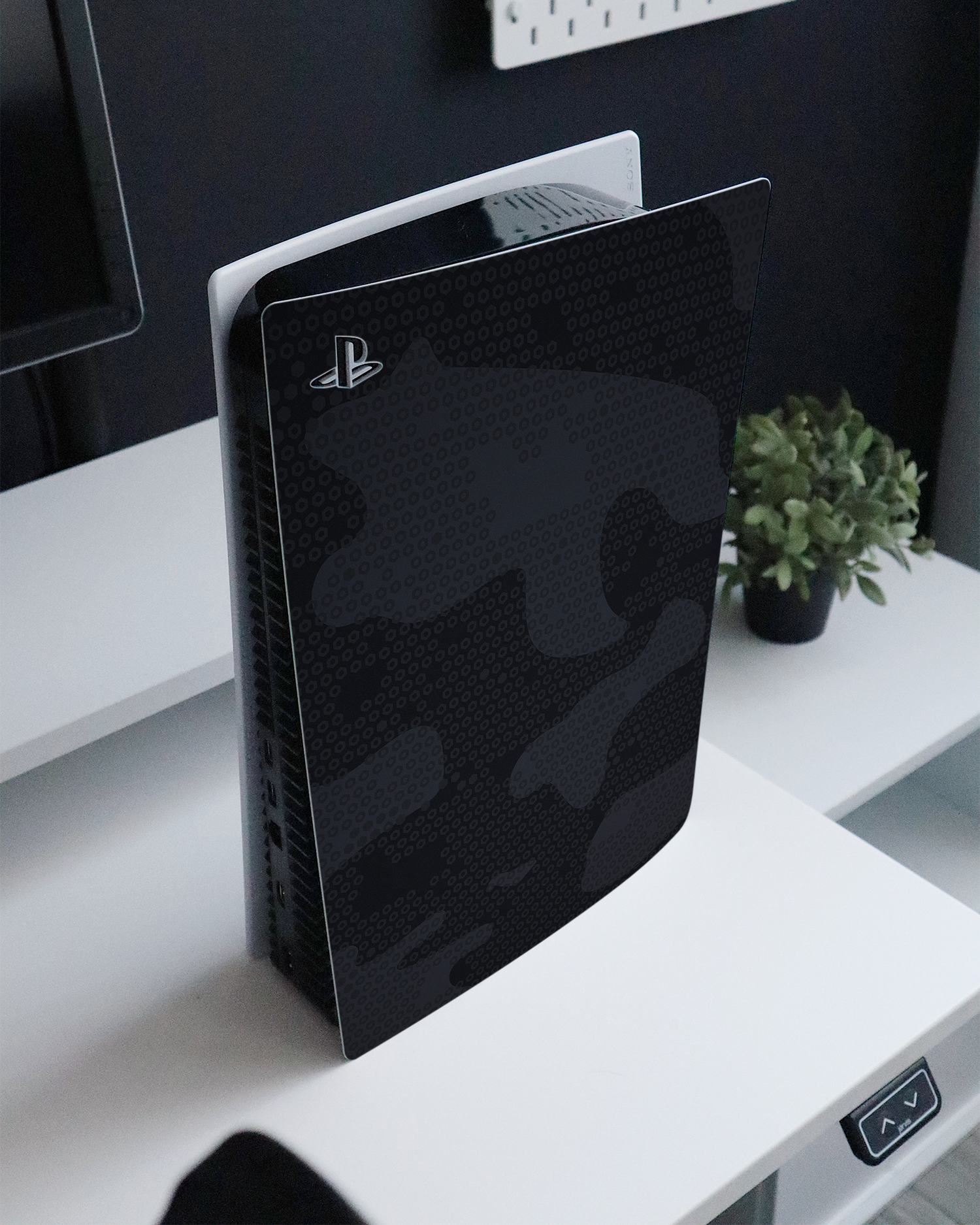 Spec Ops Dark Console Skin for Sony PlayStation 5 standing on a sideboard 