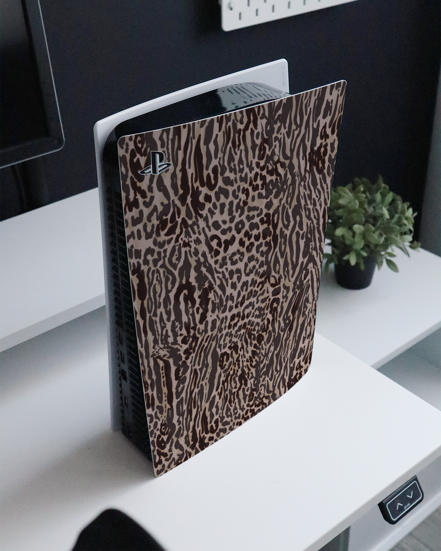 Animal Skin Tough Love Console Skin for Sony PlayStation 5 standing on a sideboard 