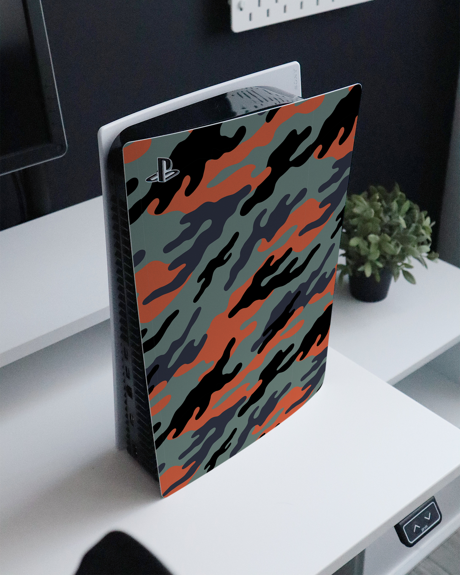 Camo Sunset Console Skin for Sony PlayStation 5 standing on a sideboard 