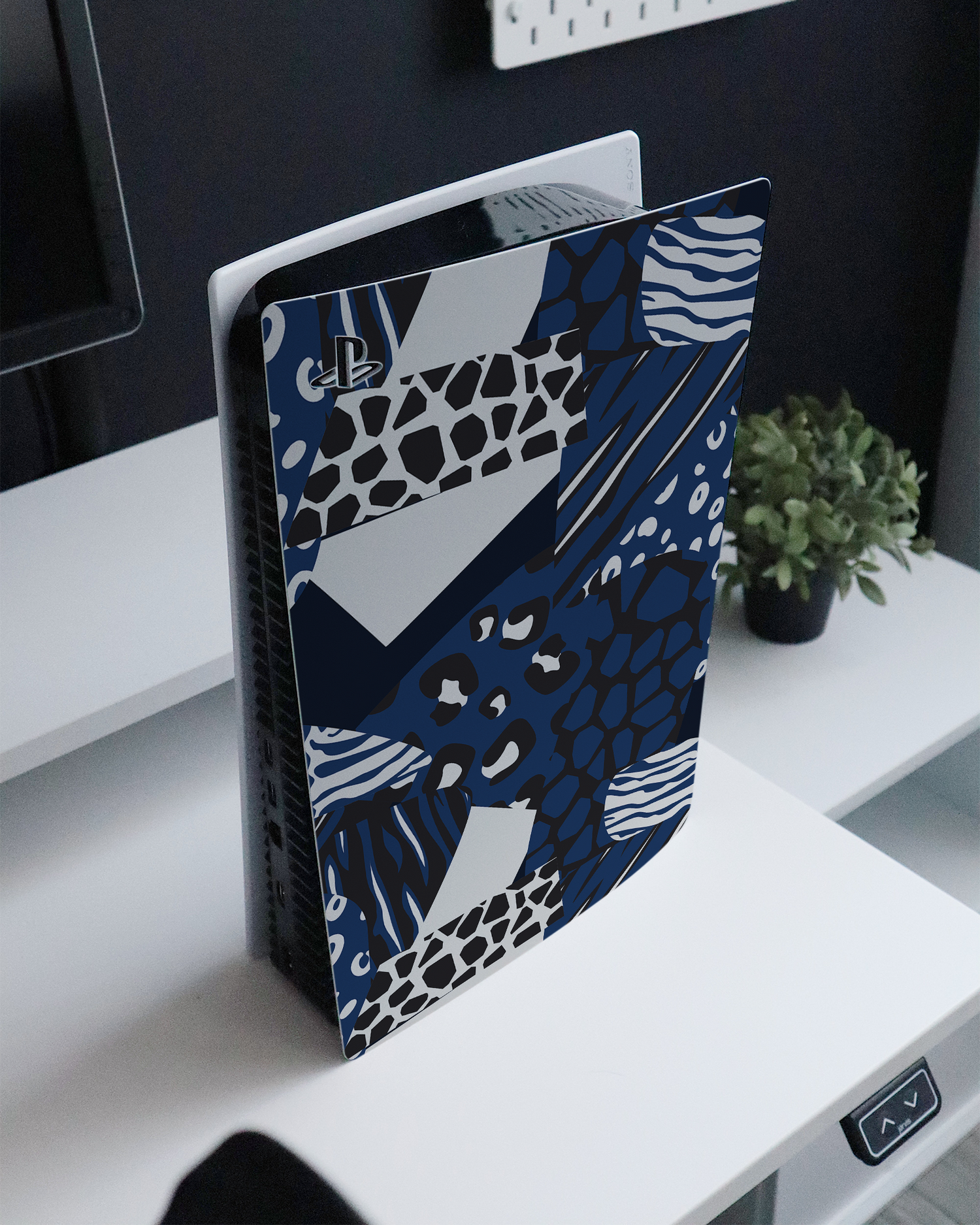 Animal Print Patchwork Console Skin for Sony PlayStation 5 standing on a sideboard 