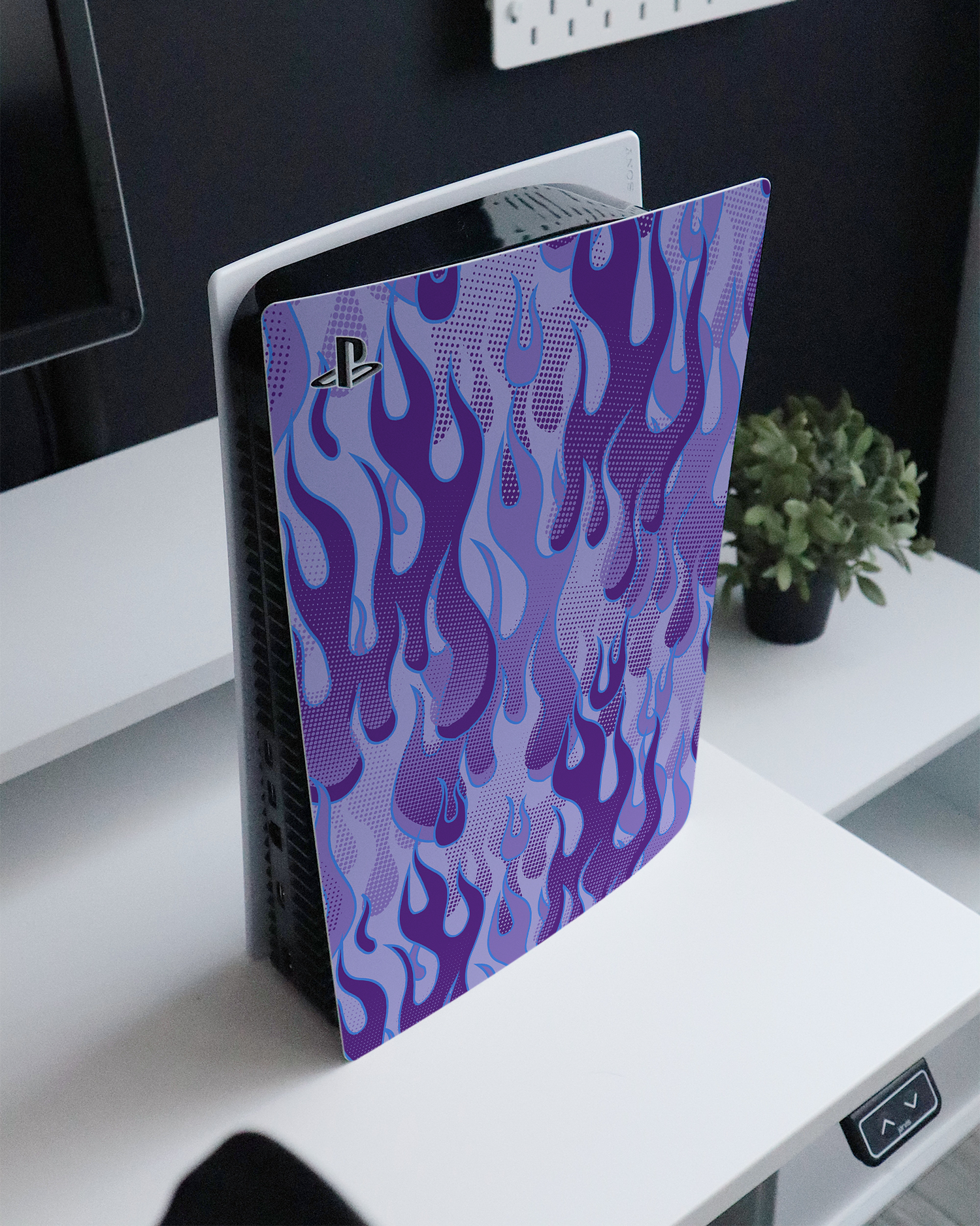 Purple Flames Console Skin for Sony PlayStation 5 standing on a sideboard 