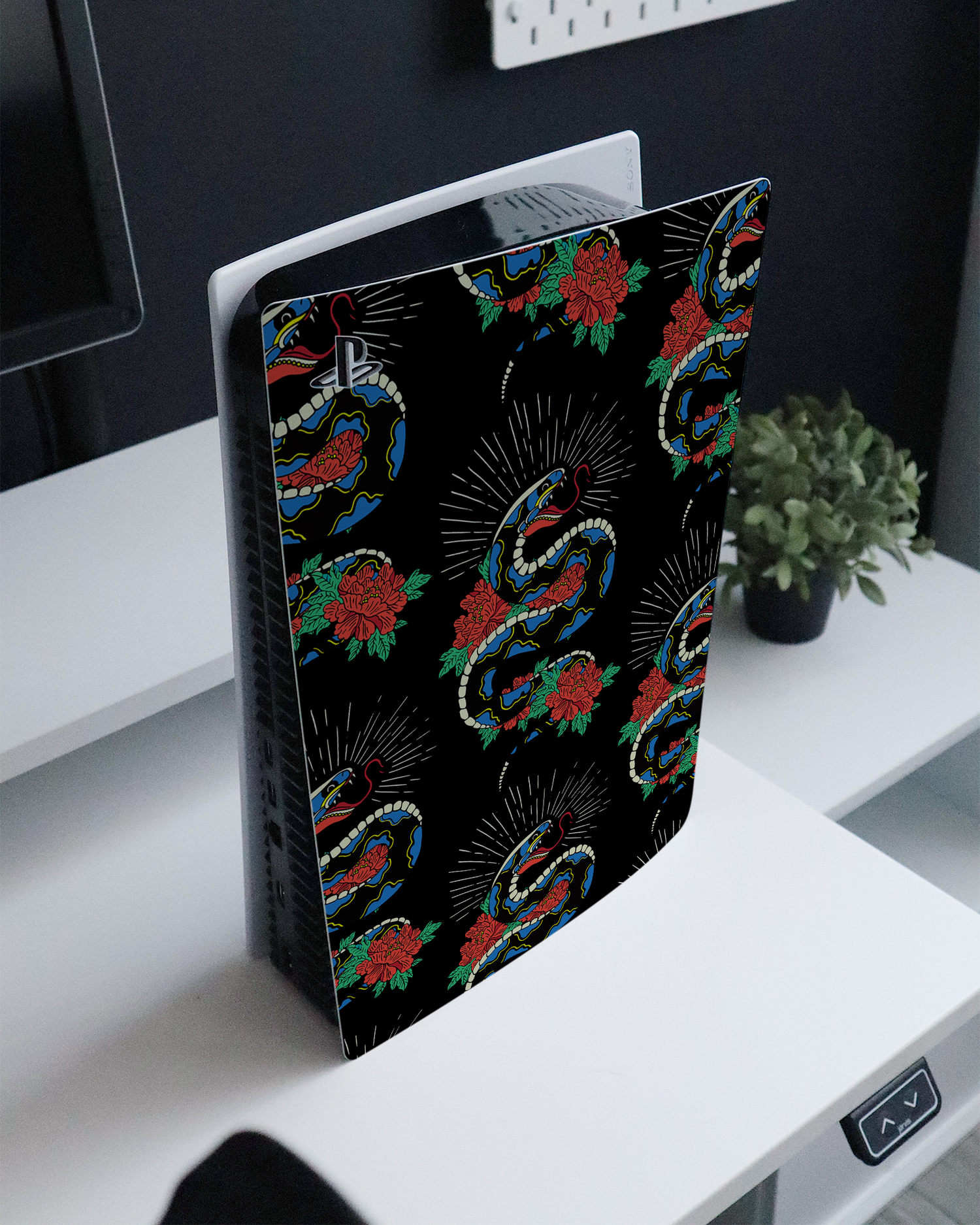 Repeating Snakes 2 Console Skin for Sony PlayStation 5 standing on a sideboard 
