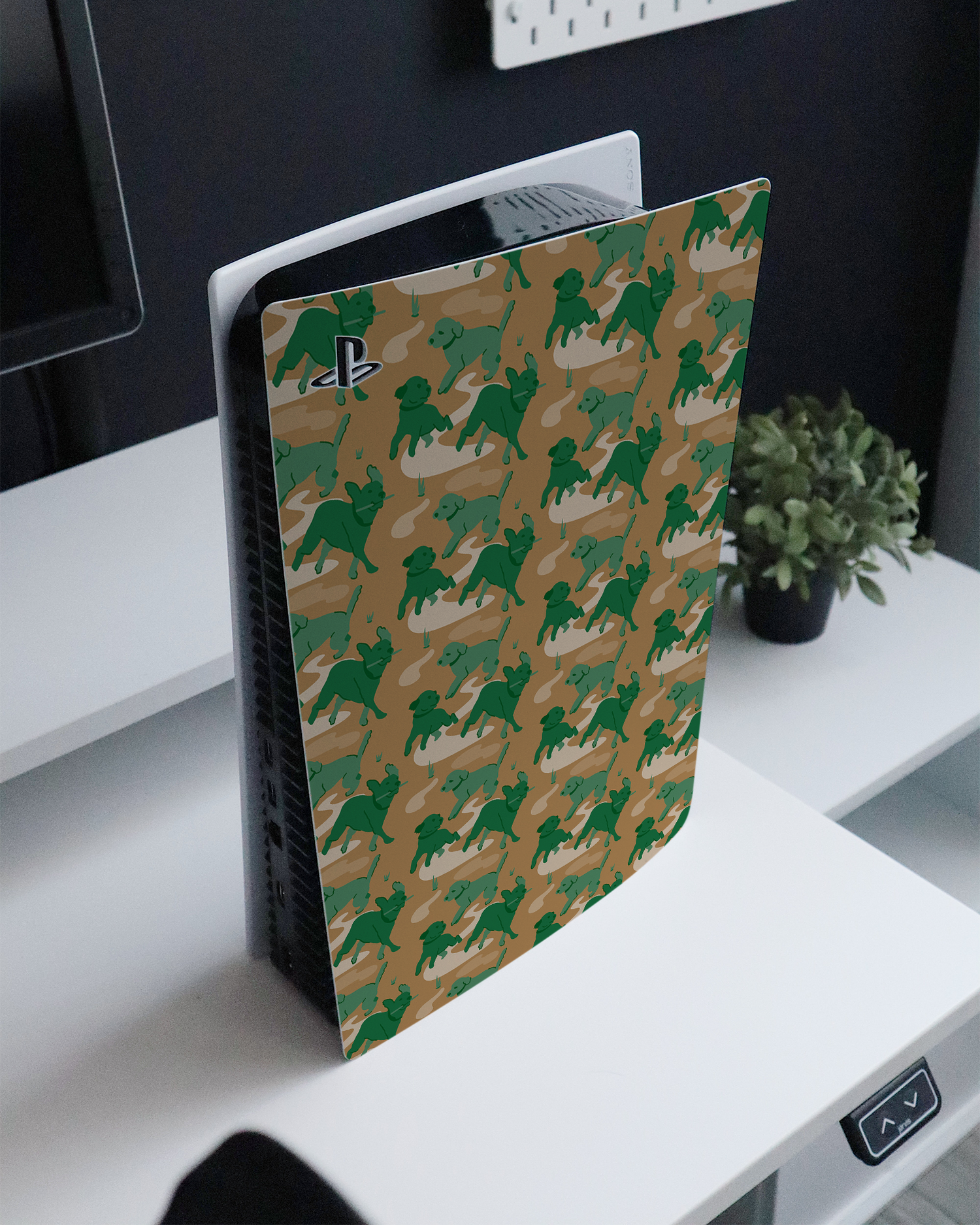 Dog Camo Console Skin for Sony PlayStation 5 standing on a sideboard 