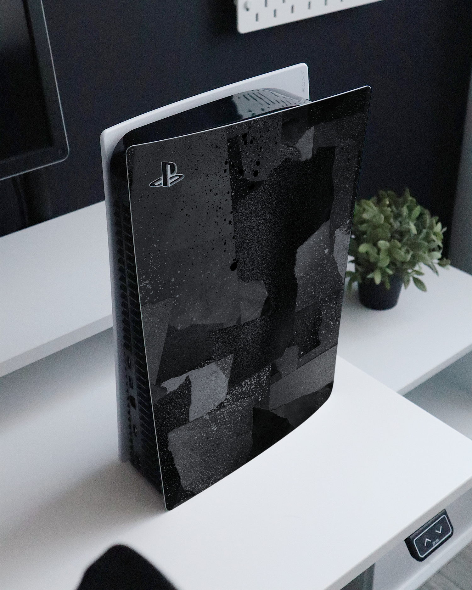 Torn Paper Collage Console Skin for Sony PlayStation 5 standing on a sideboard 