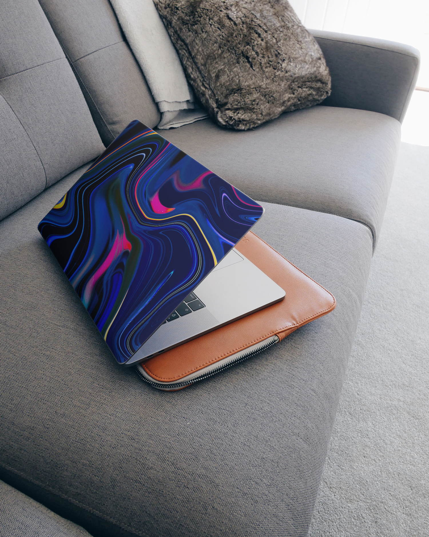 Space Swirl Laptop Skin for 15 inch Apple MacBooks on a couch