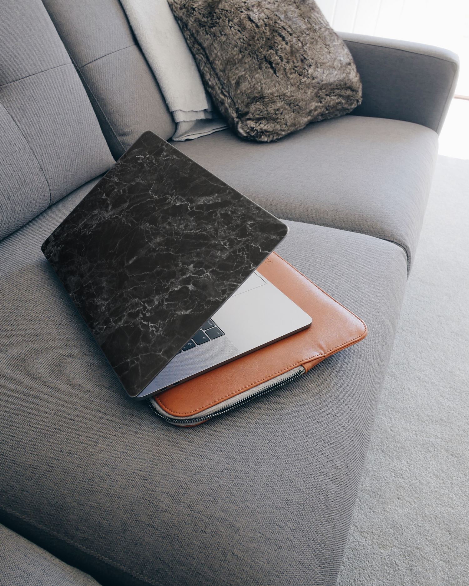Midnight Marble Laptop Skin for 15 inch Apple MacBooks on a couch