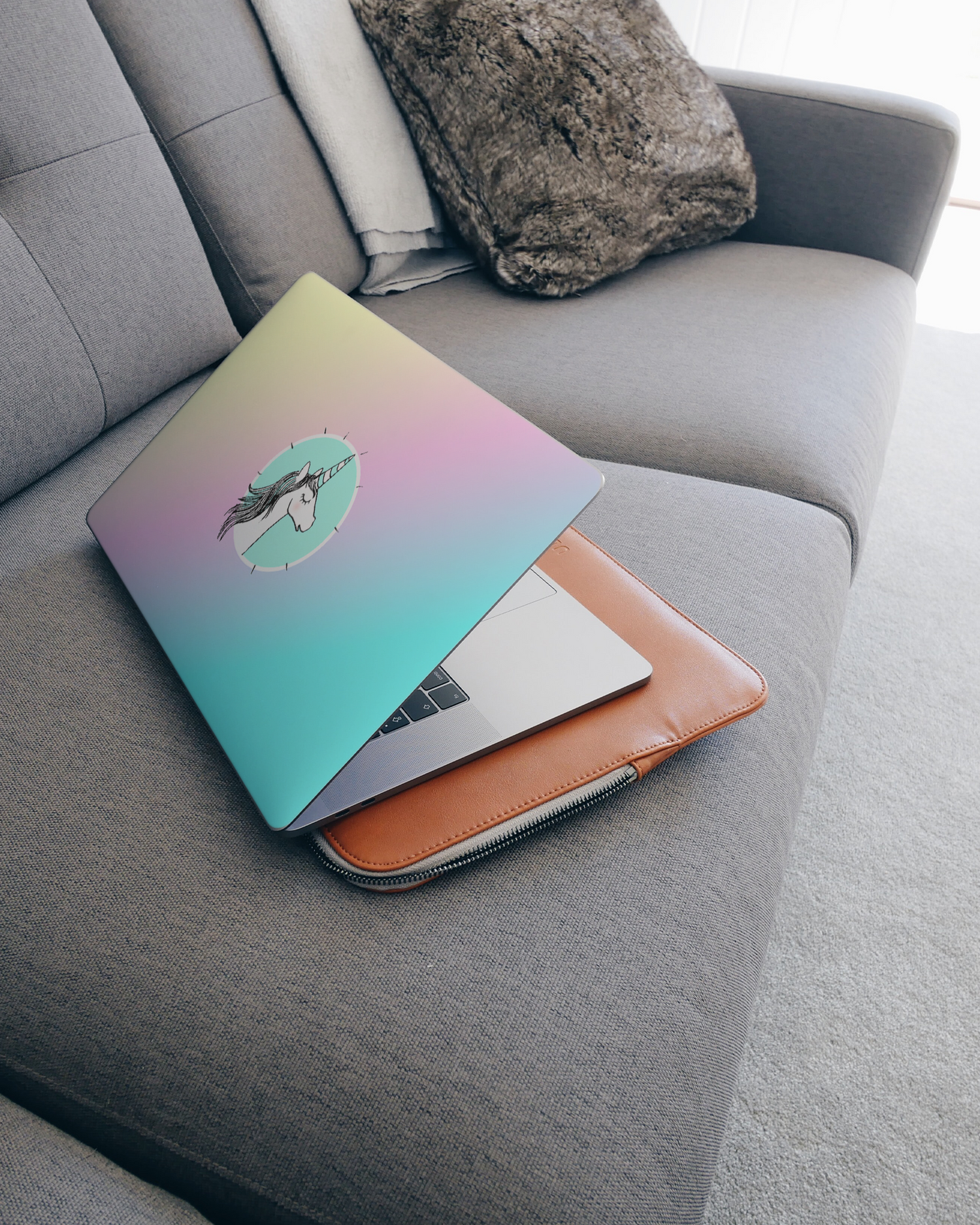 Happiness Unicorn Laptop Skin for 15 inch Apple MacBooks on a couch