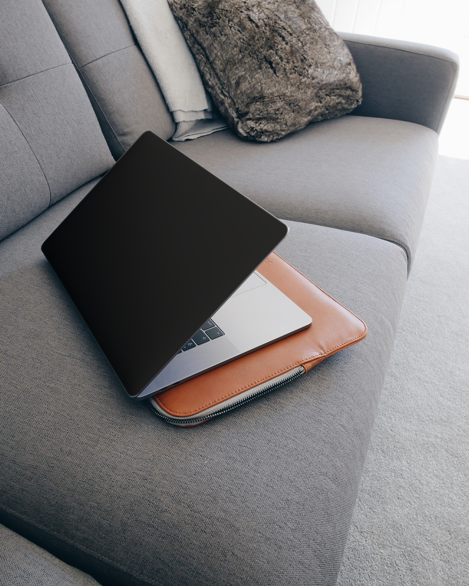 BLACK Laptop Skin for 15 inch Apple MacBooks on a couch
