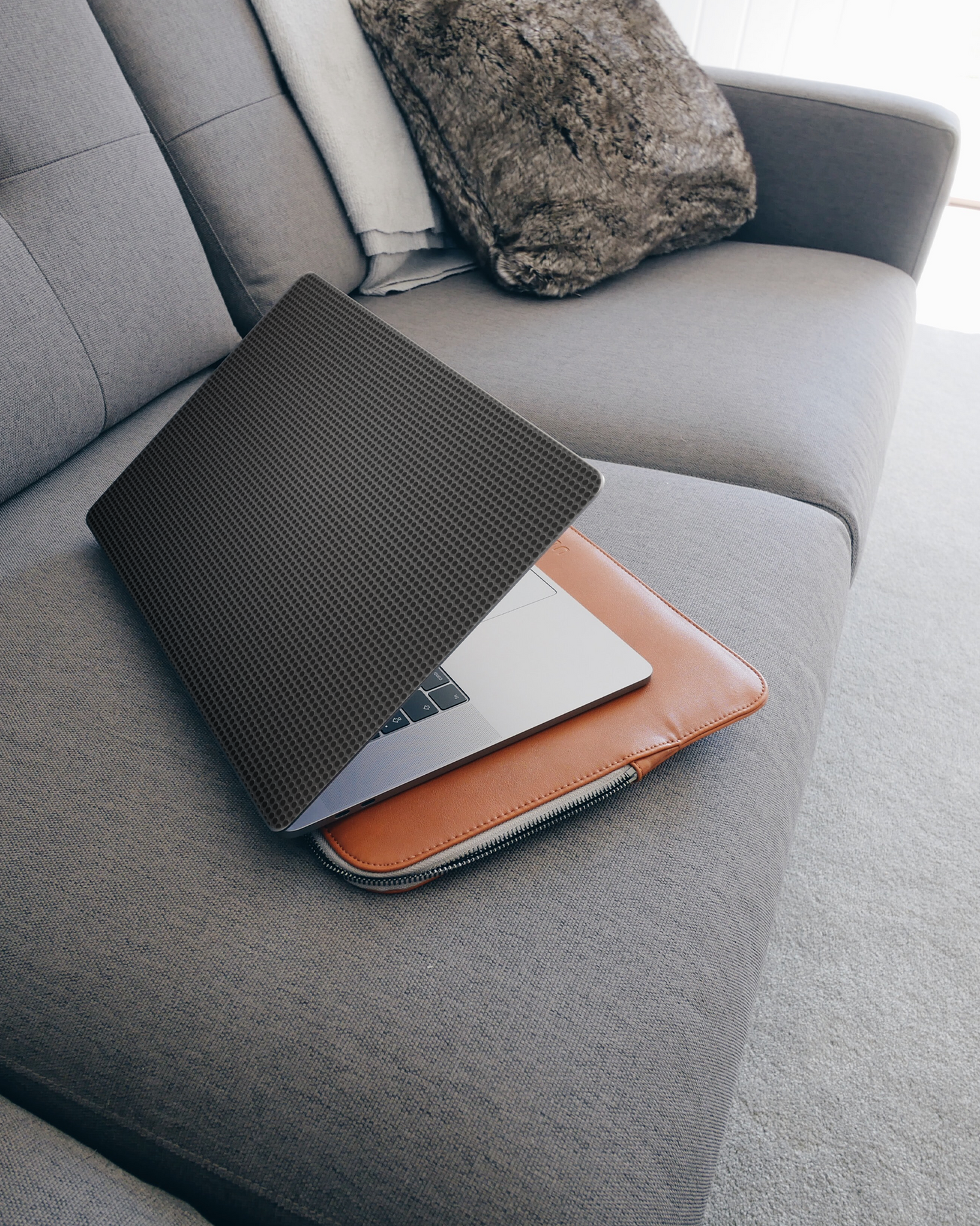 Carbon II Laptop Skin for 15 inch Apple MacBooks on a couch