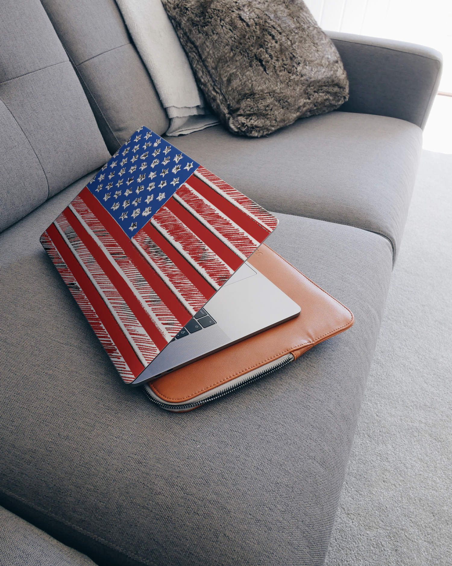 American Flag Color Laptop Skin for 15 inch Apple MacBooks on a couch