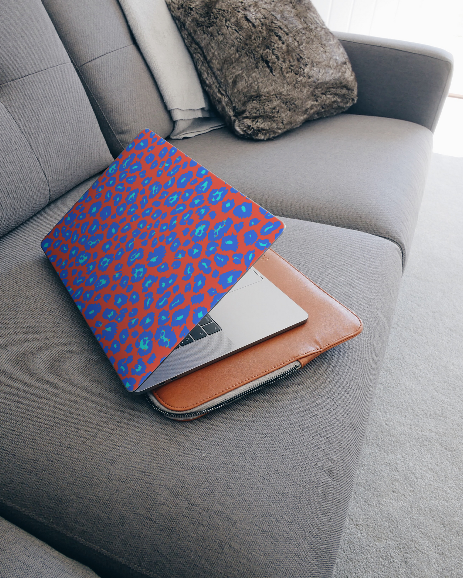 Bright Leopard Print Laptop Skin for 15 inch Apple MacBooks on a couch