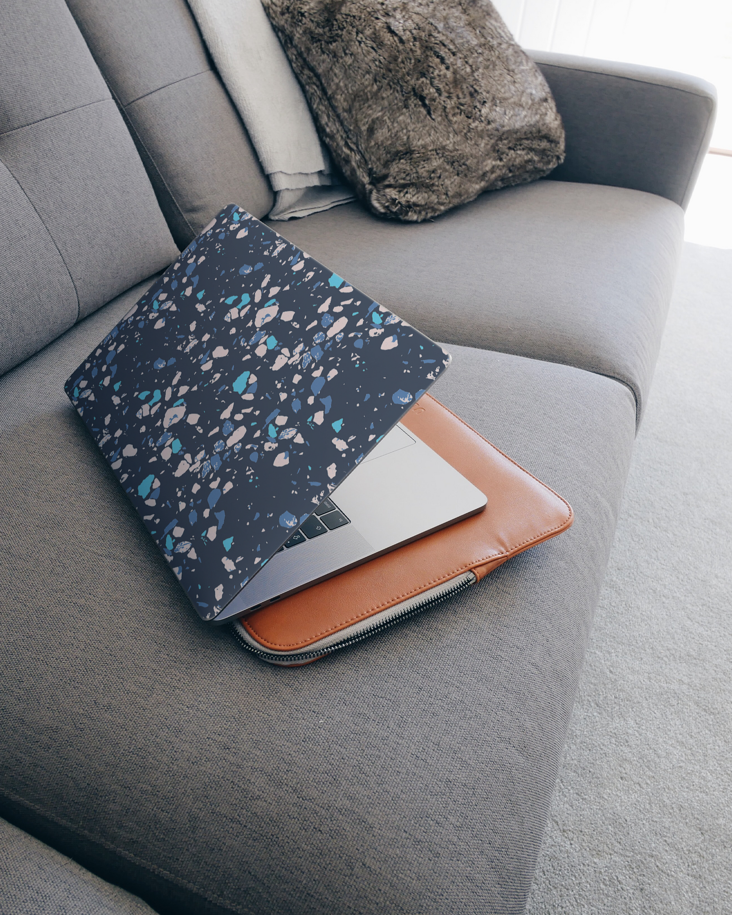 Speckled Marble Laptop Skin for 15 inch Apple MacBooks on a couch