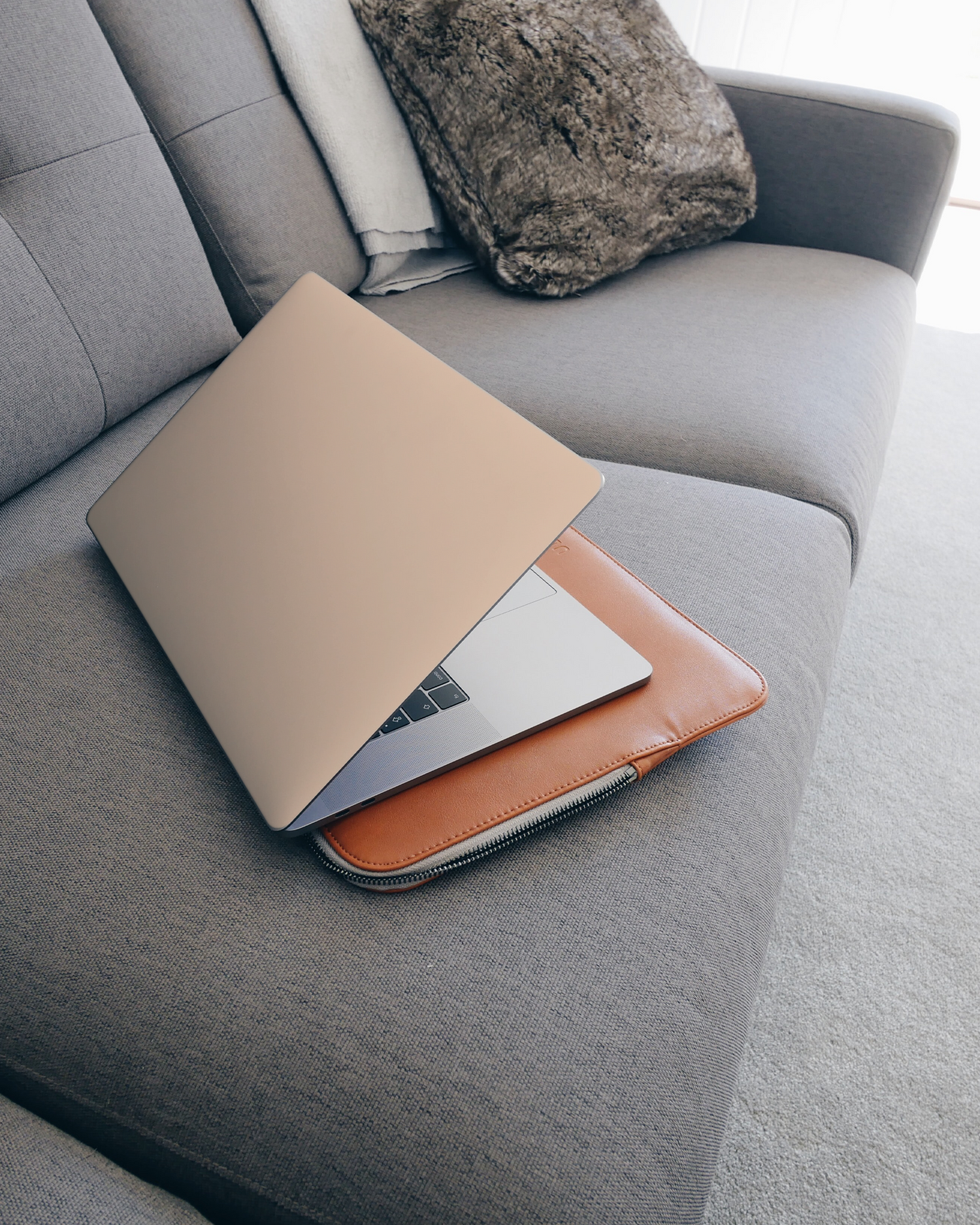 PEACH Laptop Skin for 15 inch Apple MacBooks on a couch