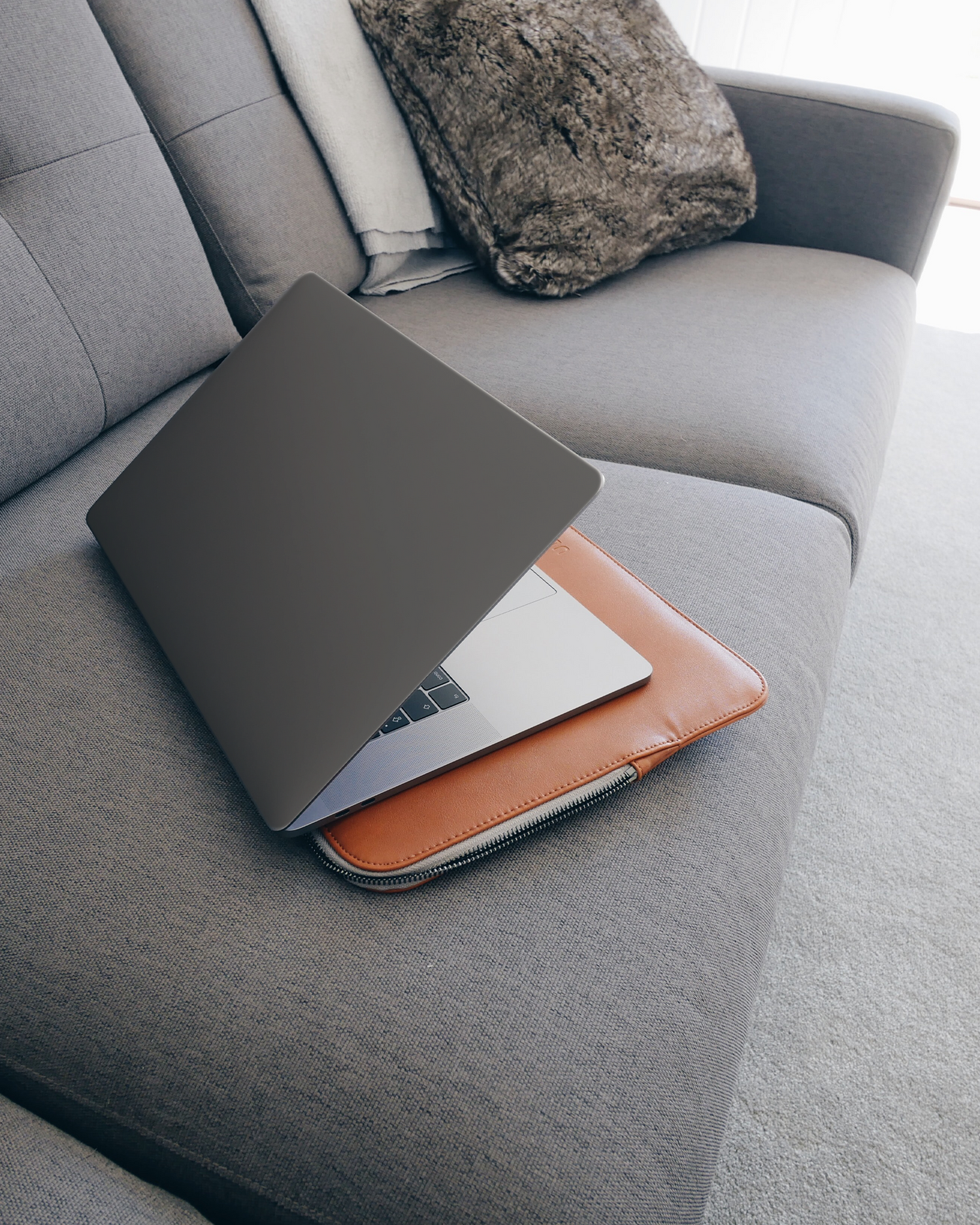 SPACE GREY Laptop Skin for 15 inch Apple MacBooks on a couch