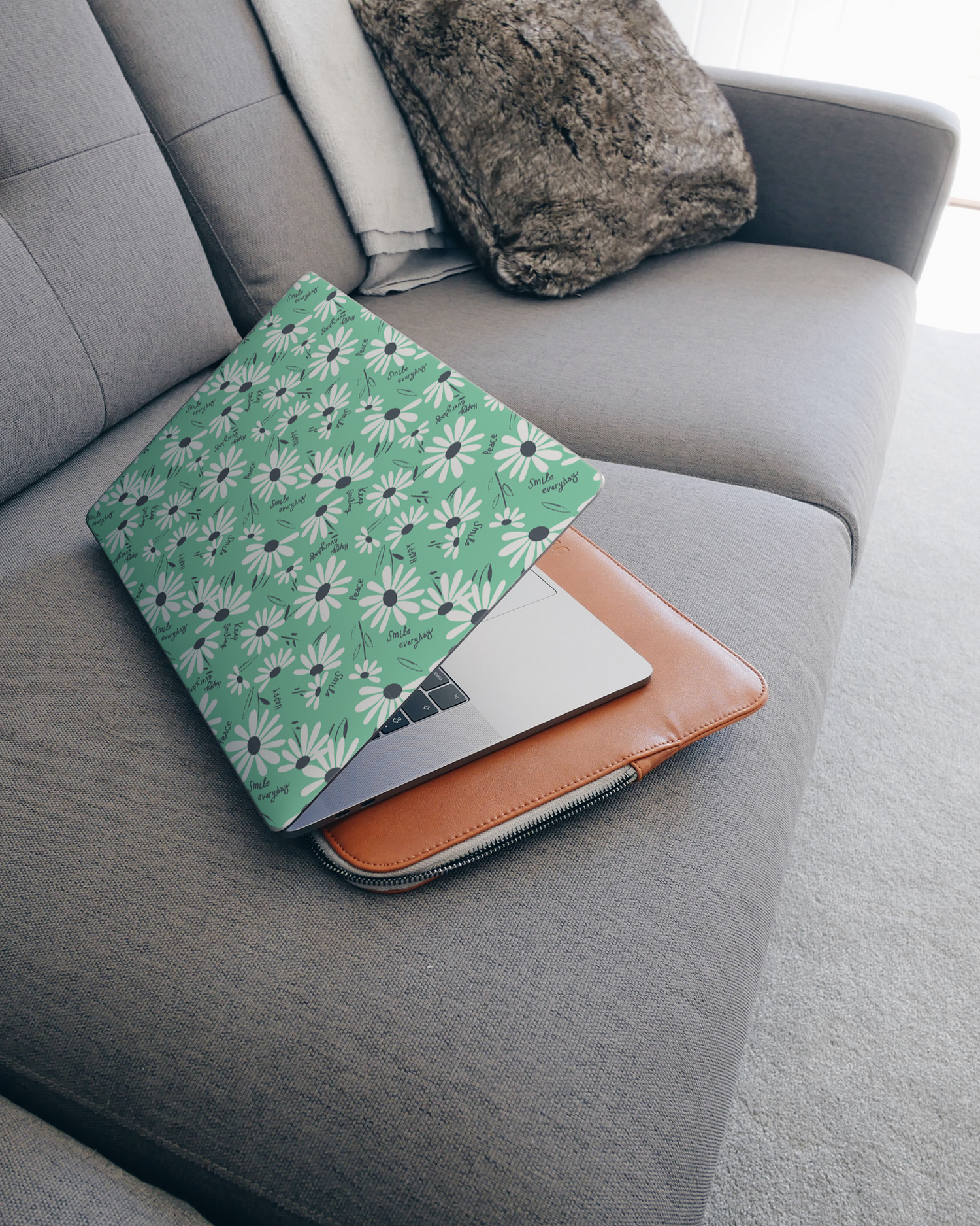 Positive Daisies Laptop Skin for 15 inch Apple MacBooks on a couch