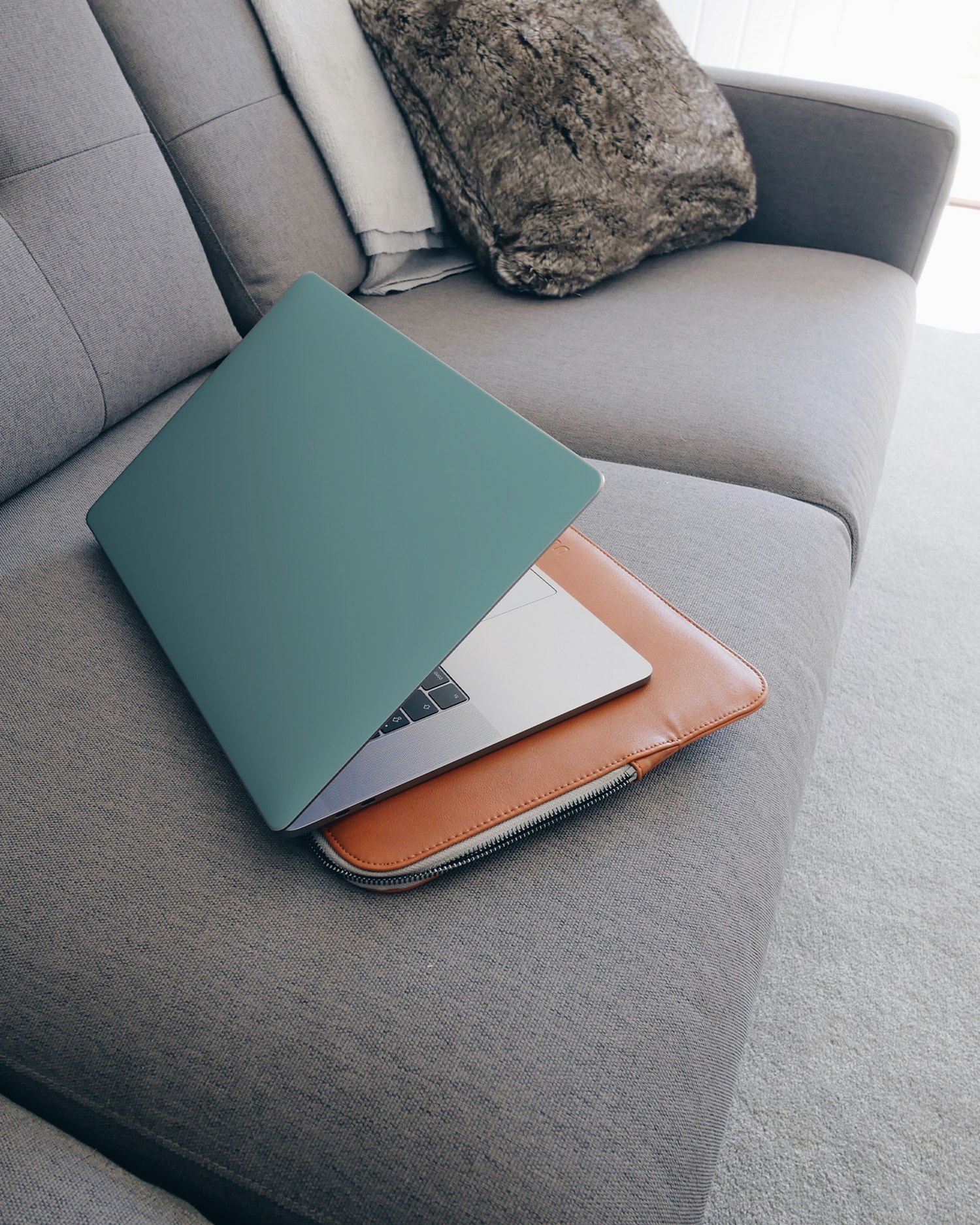 TURQUOISE Laptop Skin for 15 inch Apple MacBooks on a couch