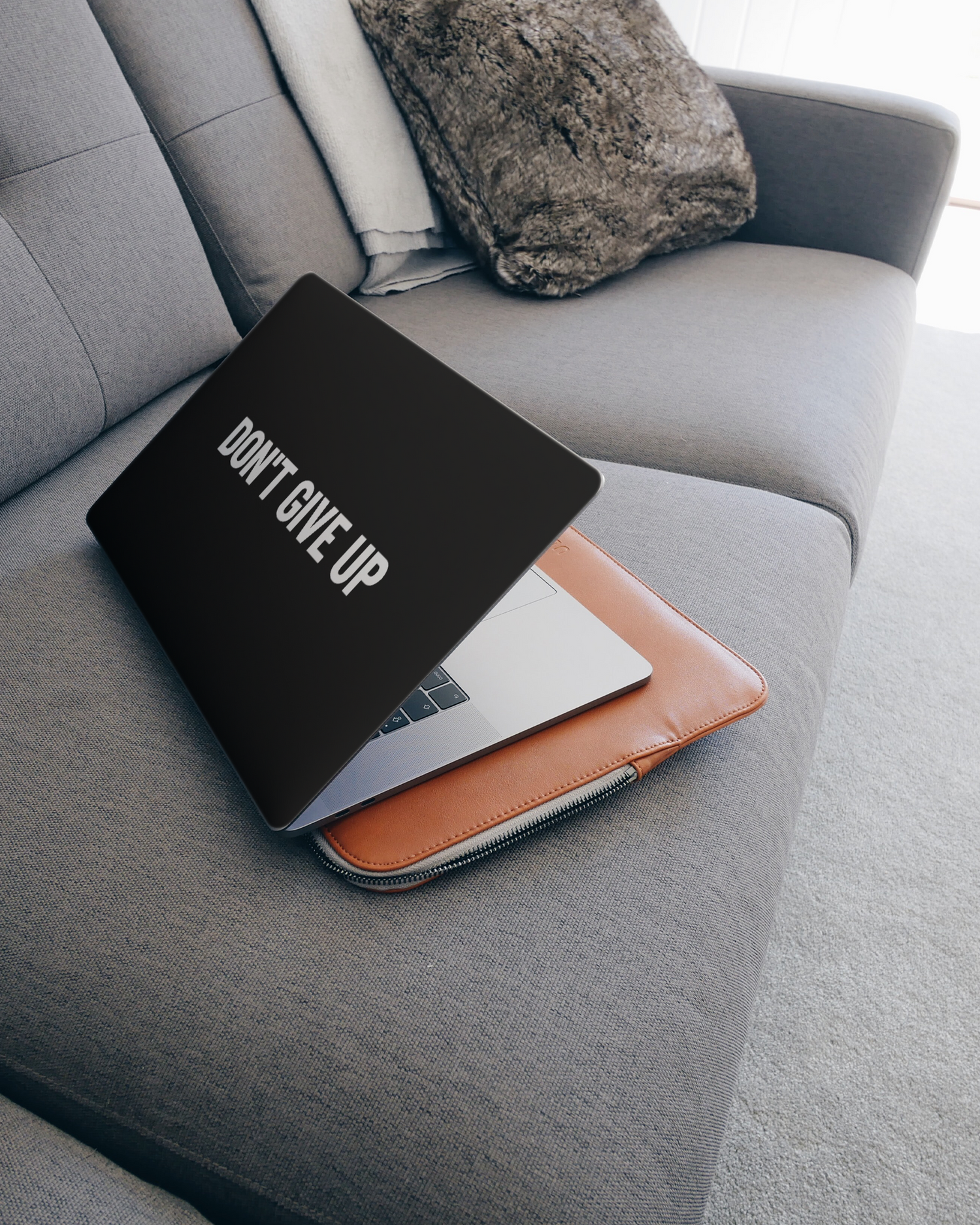 Dont Give Up Laptop Skin for 15 inch Apple MacBooks on a couch