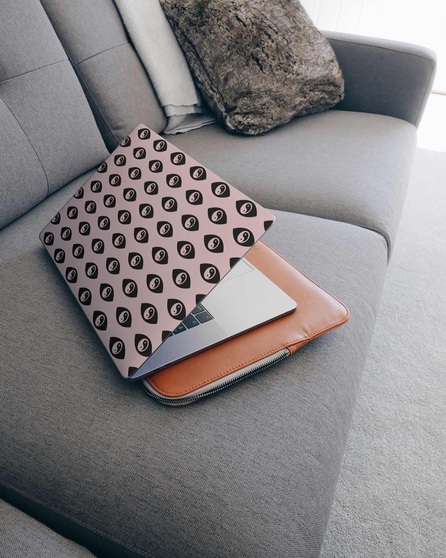 Yin Yang Repeat Laptop Skin for 15 inch Apple MacBooks on a couch
