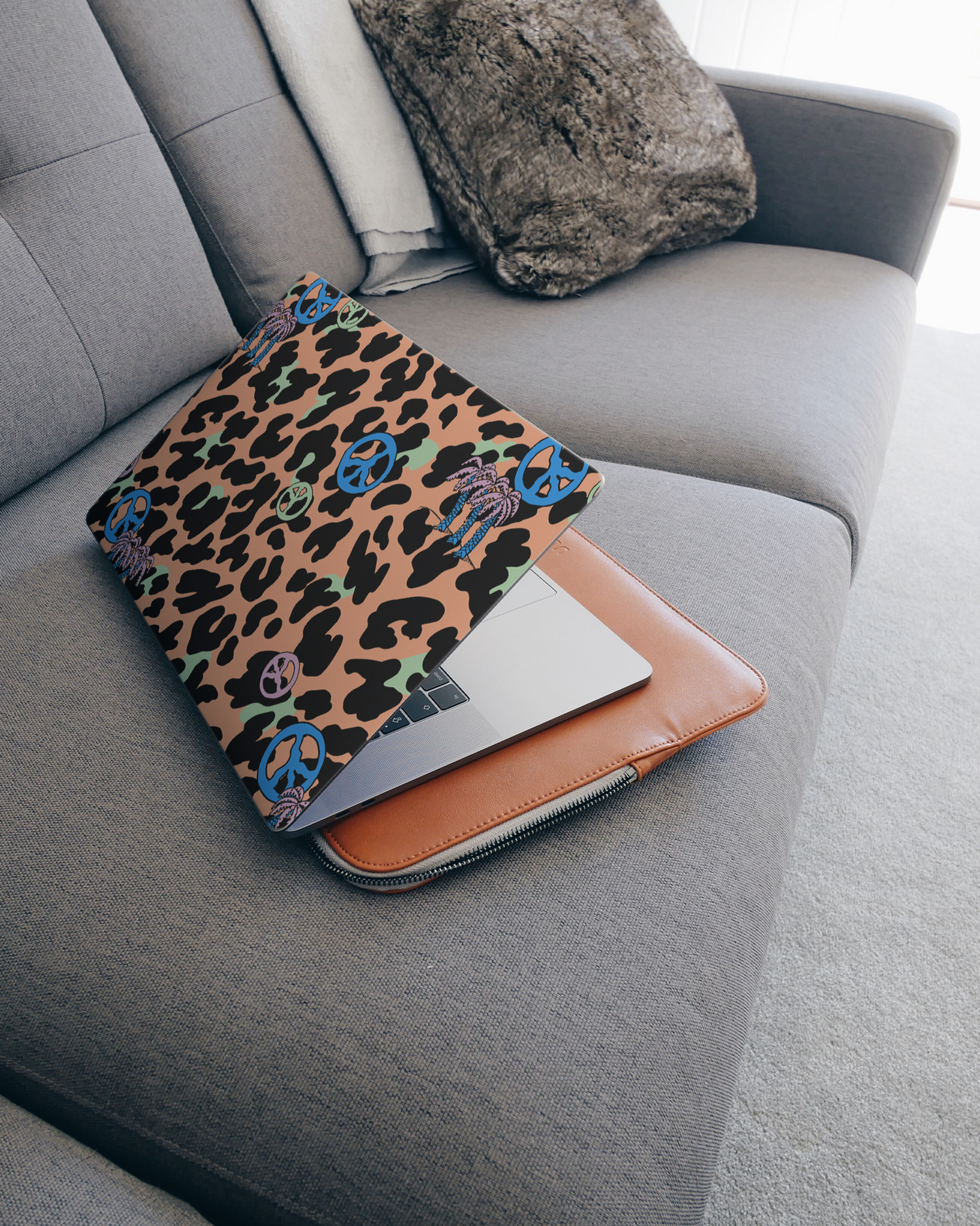 Leopard Peace Palms Laptop Skin for 15 inch Apple MacBooks on a couch