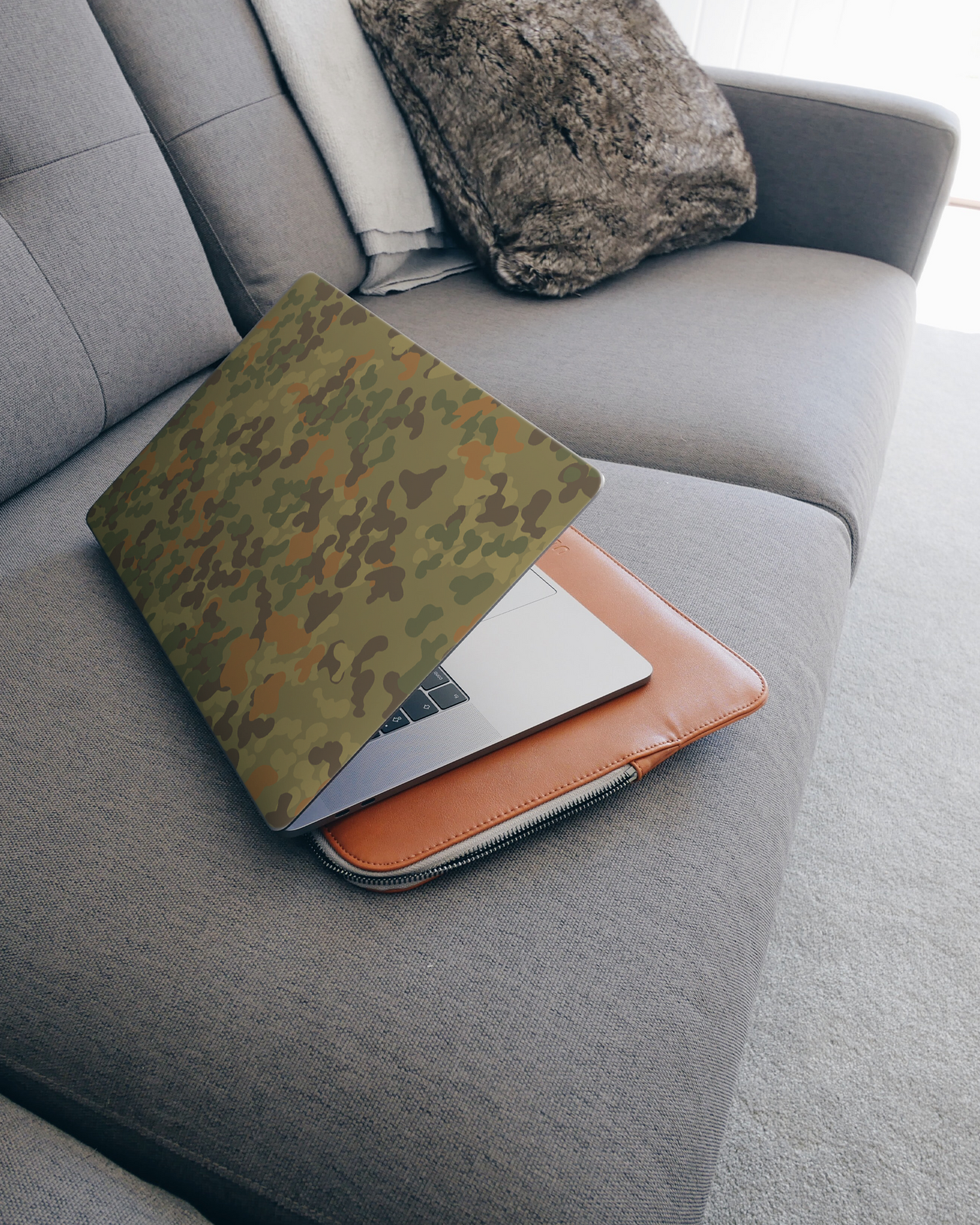 Spot Camo Laptop Skin for 15 inch Apple MacBooks on a couch
