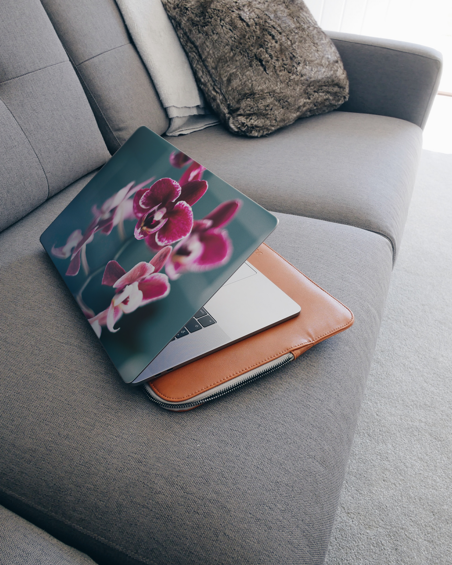 Orchid Laptop Skin for 15 inch Apple MacBooks on a couch