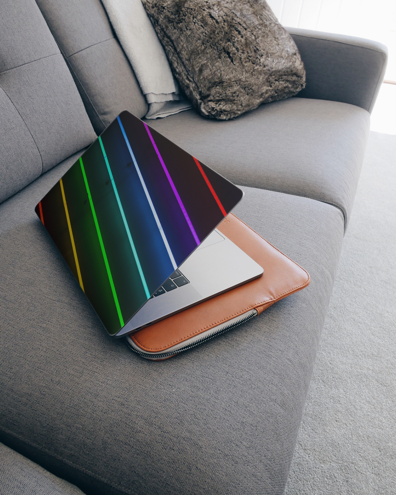 LGBTQ Laptop Skin for 15 inch Apple MacBooks on a couch