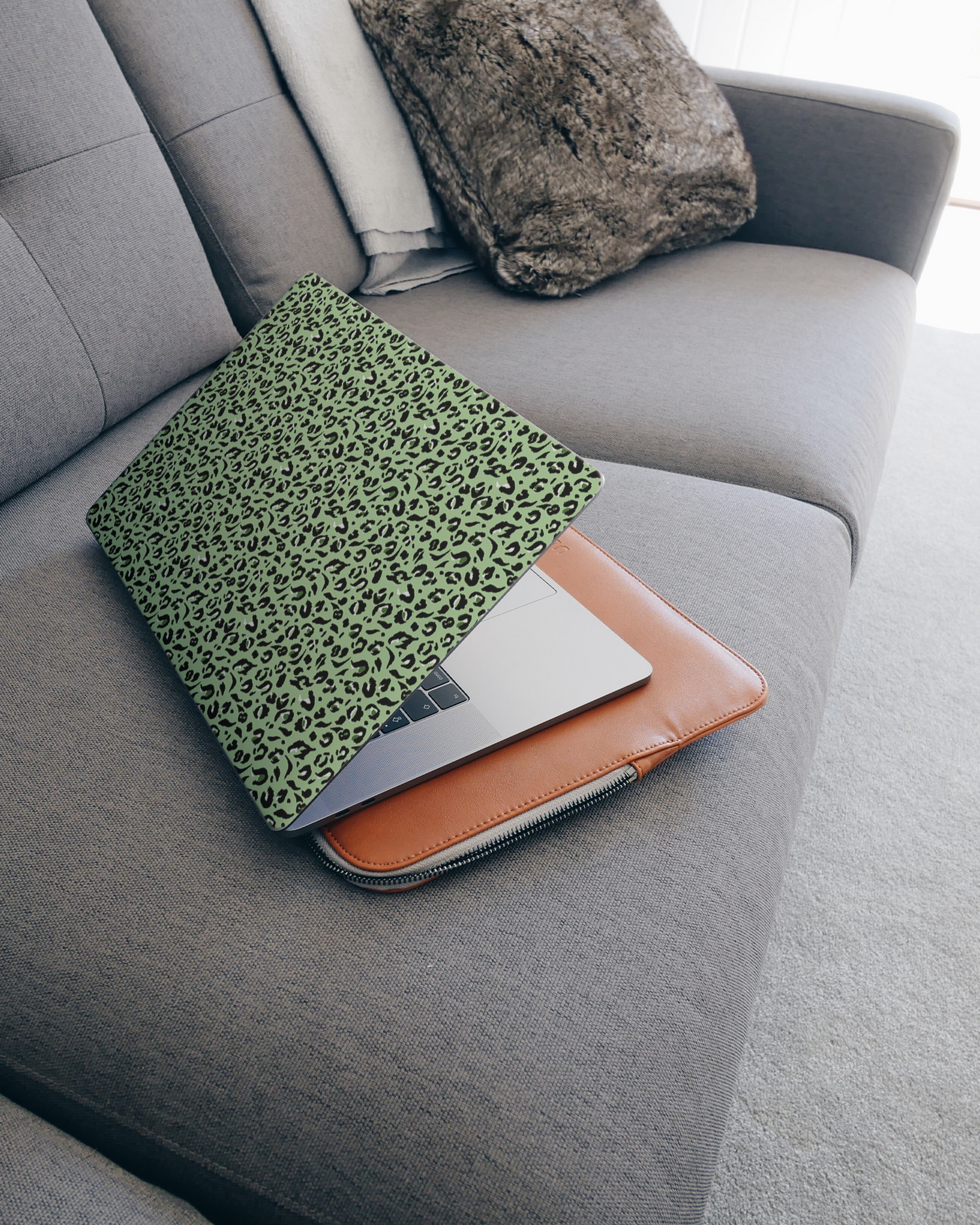 Mint Leopard Laptop Skin for 15 inch Apple MacBooks on a couch