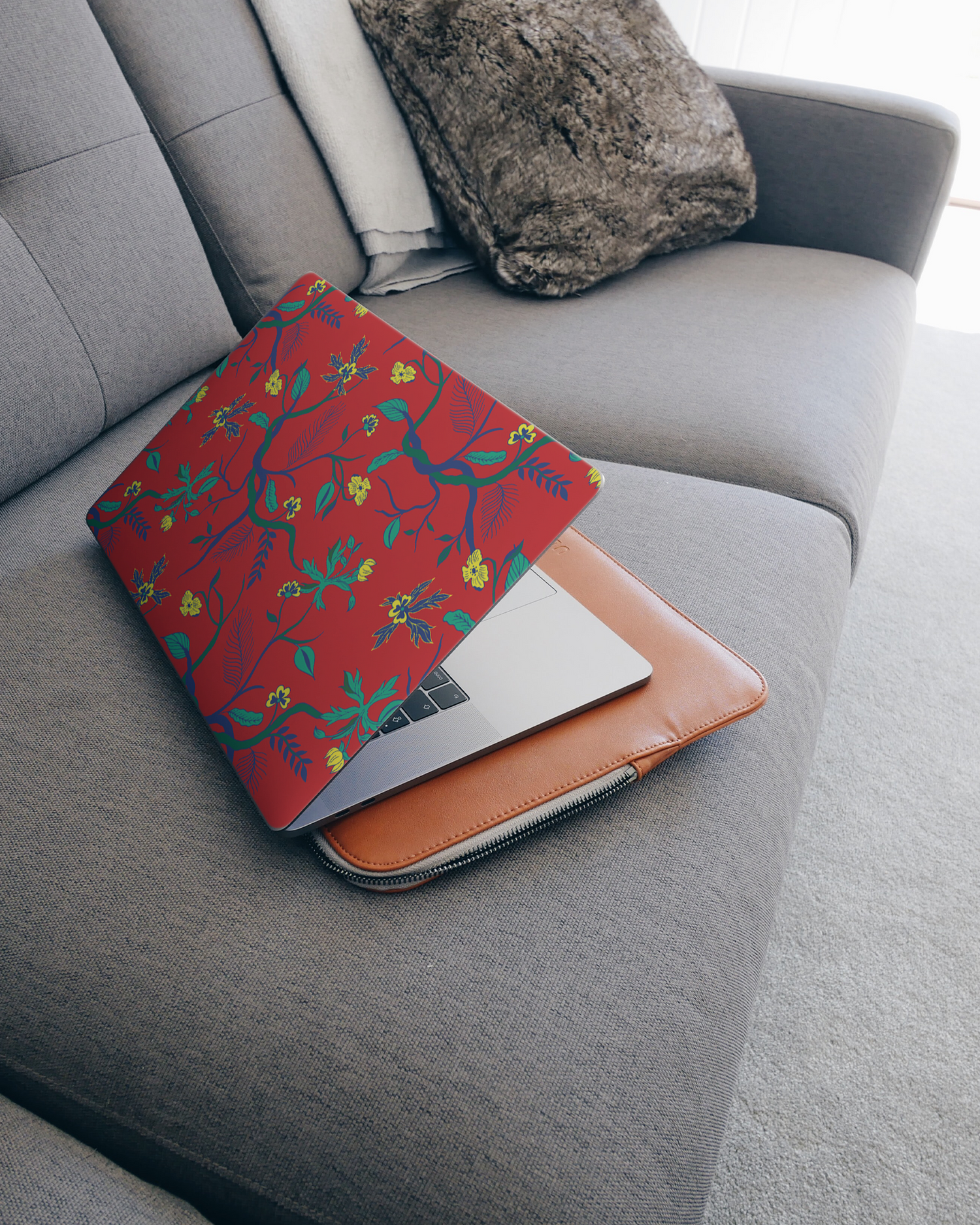 Ultra Red Floral Laptop Skin for 15 inch Apple MacBooks on a couch