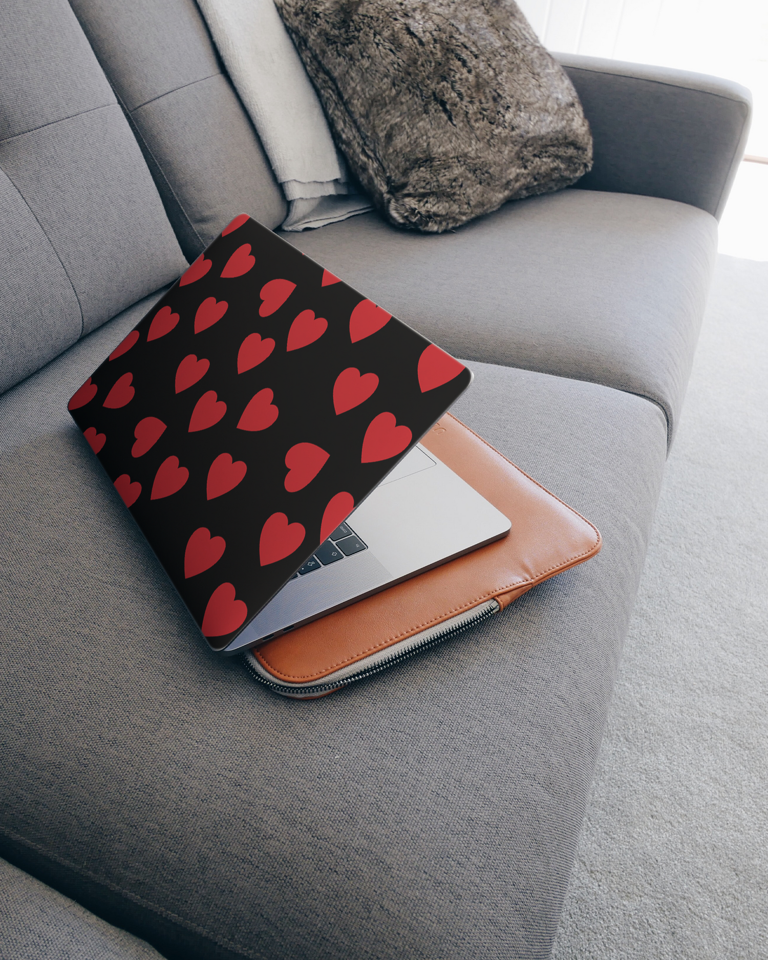 Repeating Hearts Laptop Skin for 15 inch Apple MacBooks on a couch