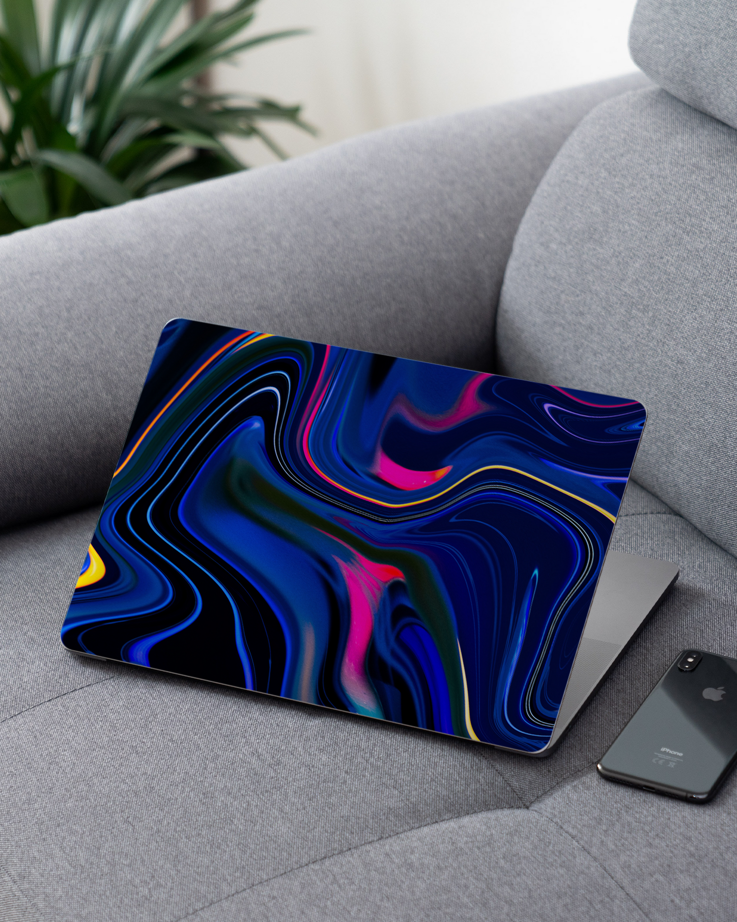 Space Swirl Laptop Skin for 13 inch Apple MacBooks on a couch