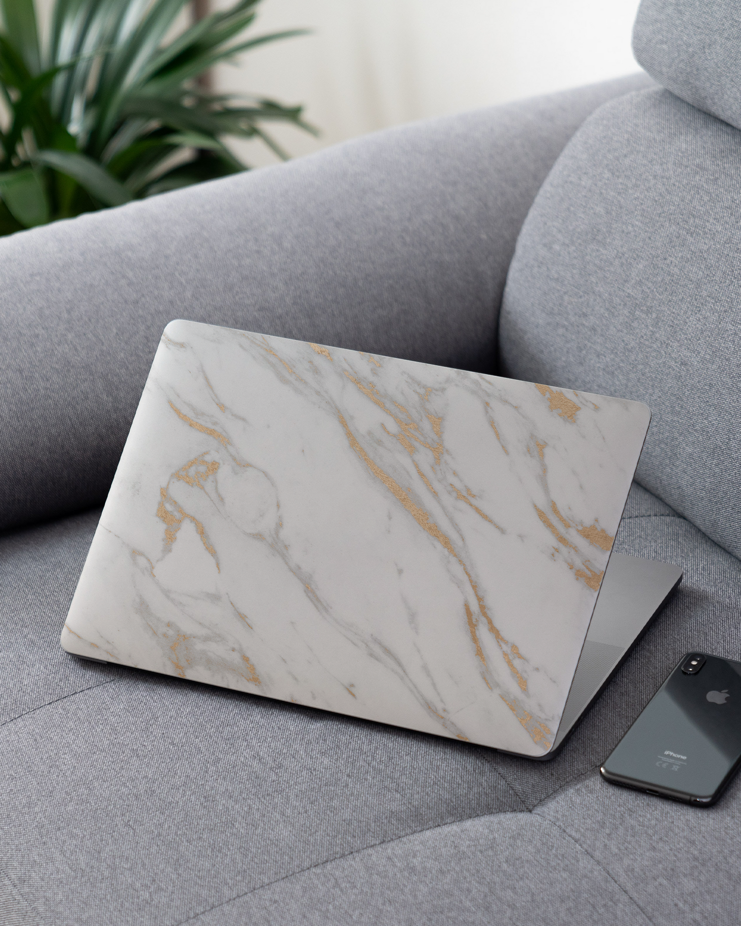 Gold Marble Elegance Laptop Skin for 13 inch Apple MacBooks on a couch