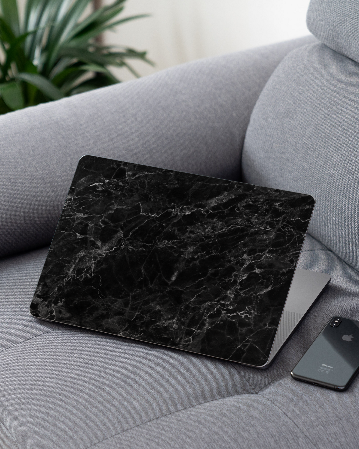 Midnight Marble Laptop Skin for 13 inch Apple MacBooks on a couch