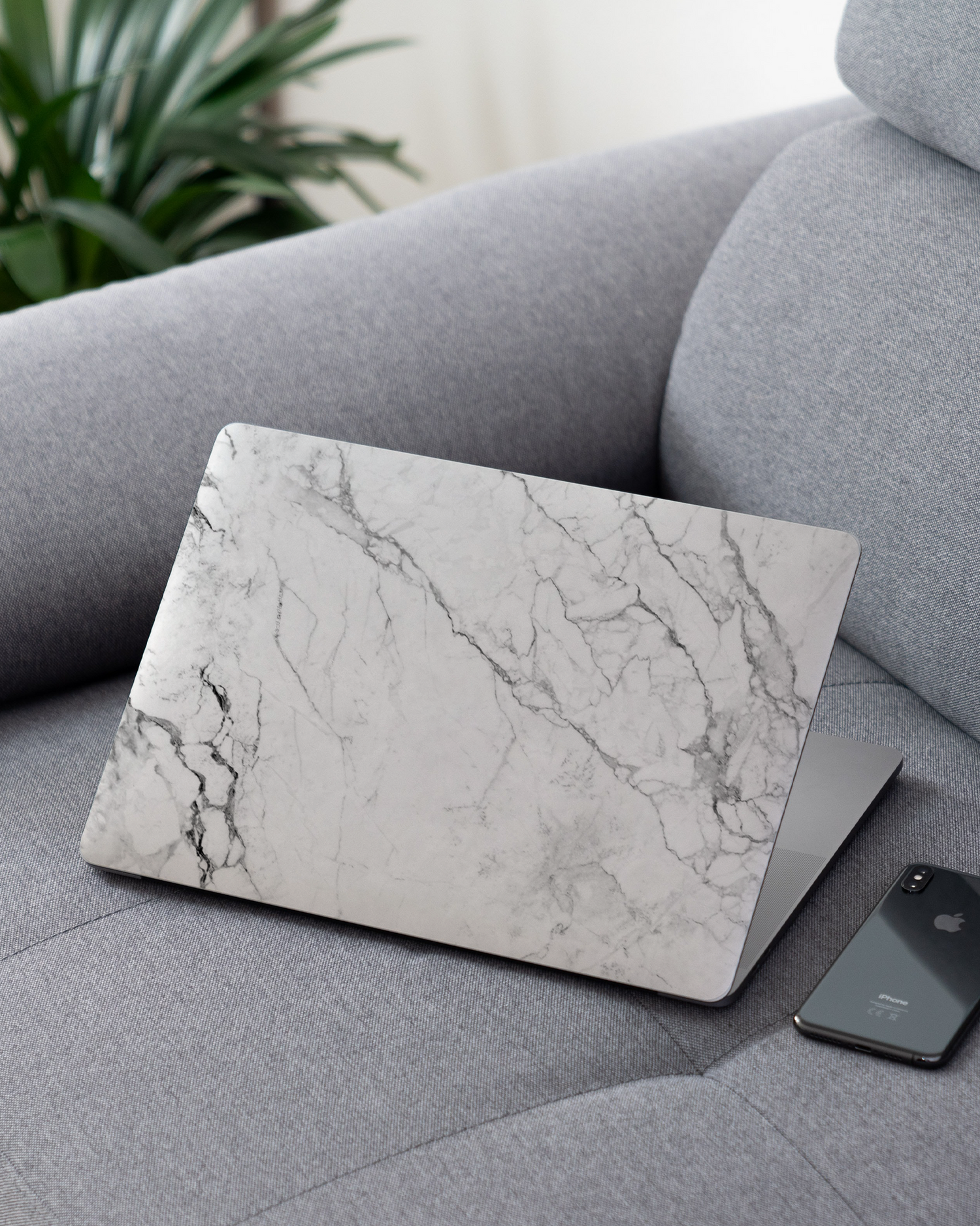White Marble Laptop Skin for 13 inch Apple MacBooks on a couch
