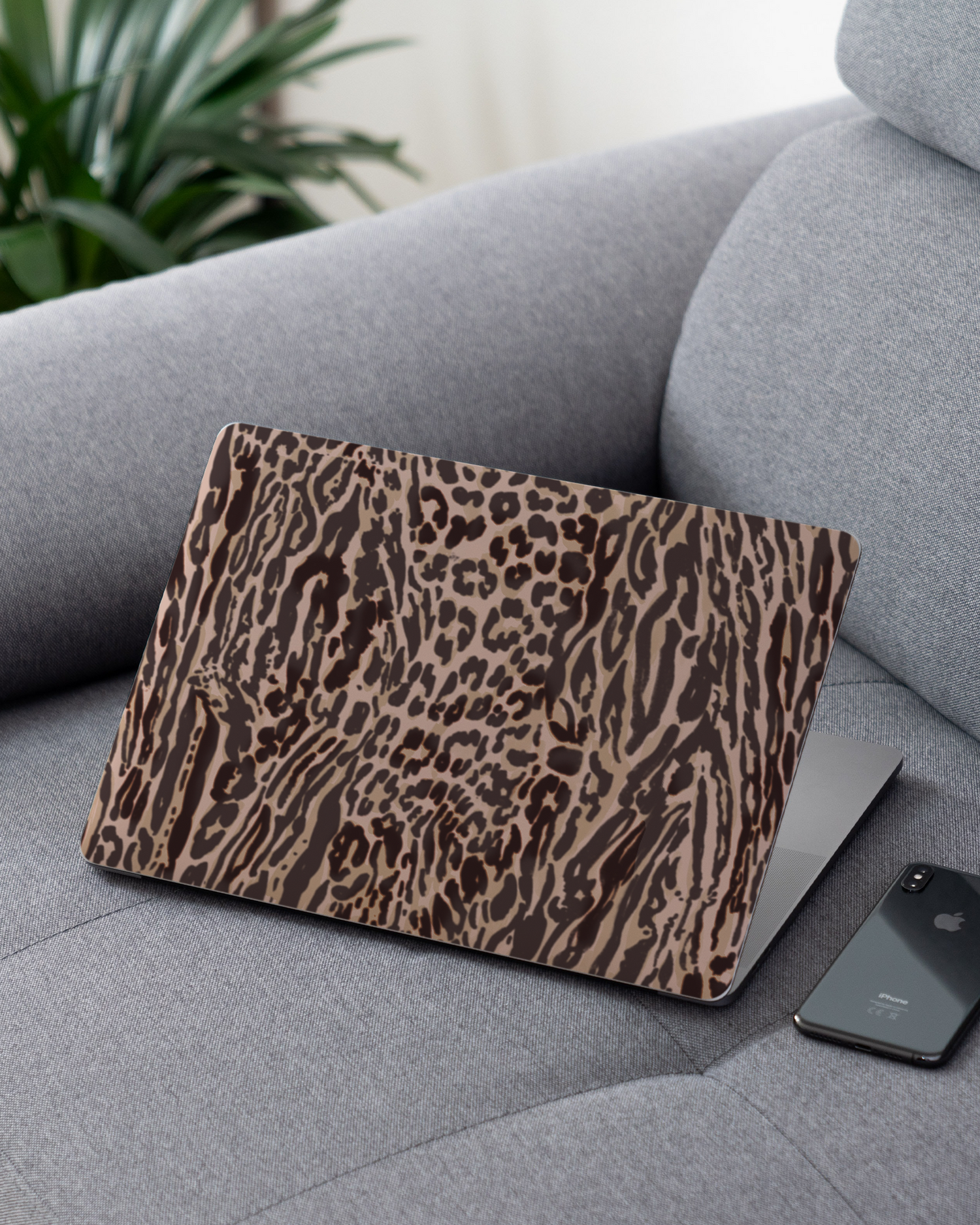 Animal Skin Tough Love Laptop Skin for 13 inch Apple MacBooks on a couch