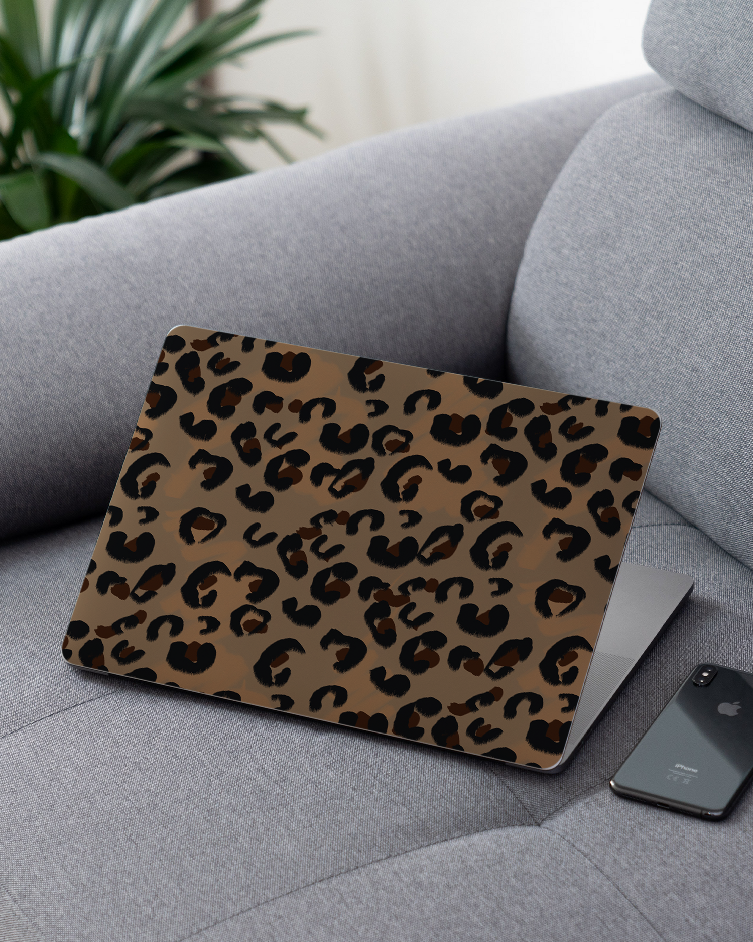 Leopard Repeat Laptop Skin for 13 inch Apple MacBooks on a couch