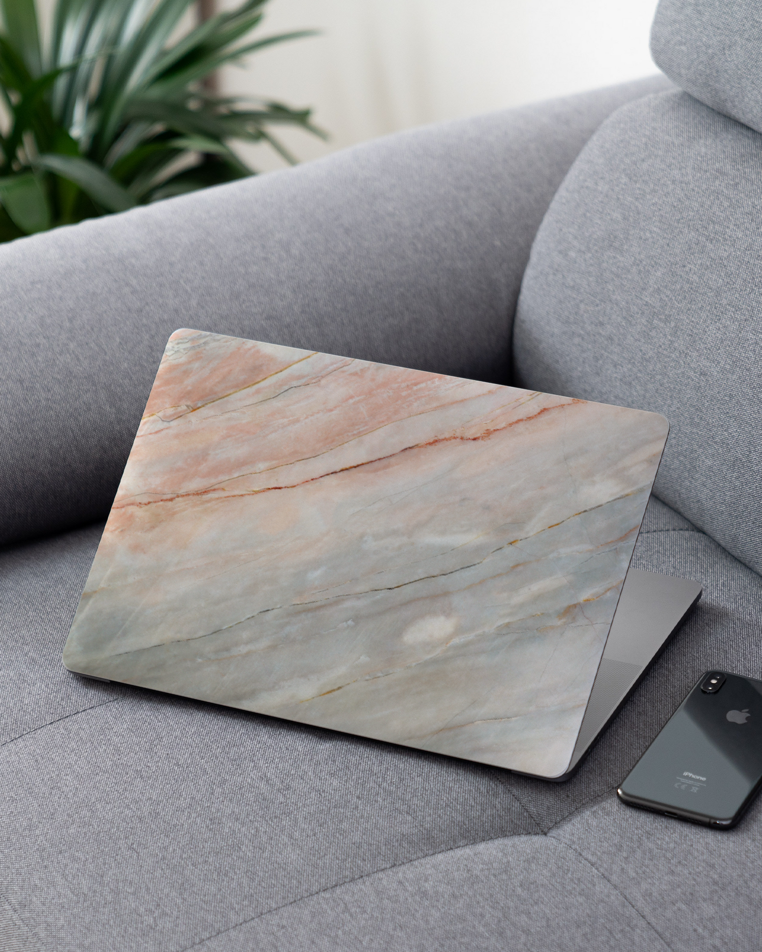Mother of Pearl Marble Laptop Skin for 13 inch Apple MacBooks on a couch