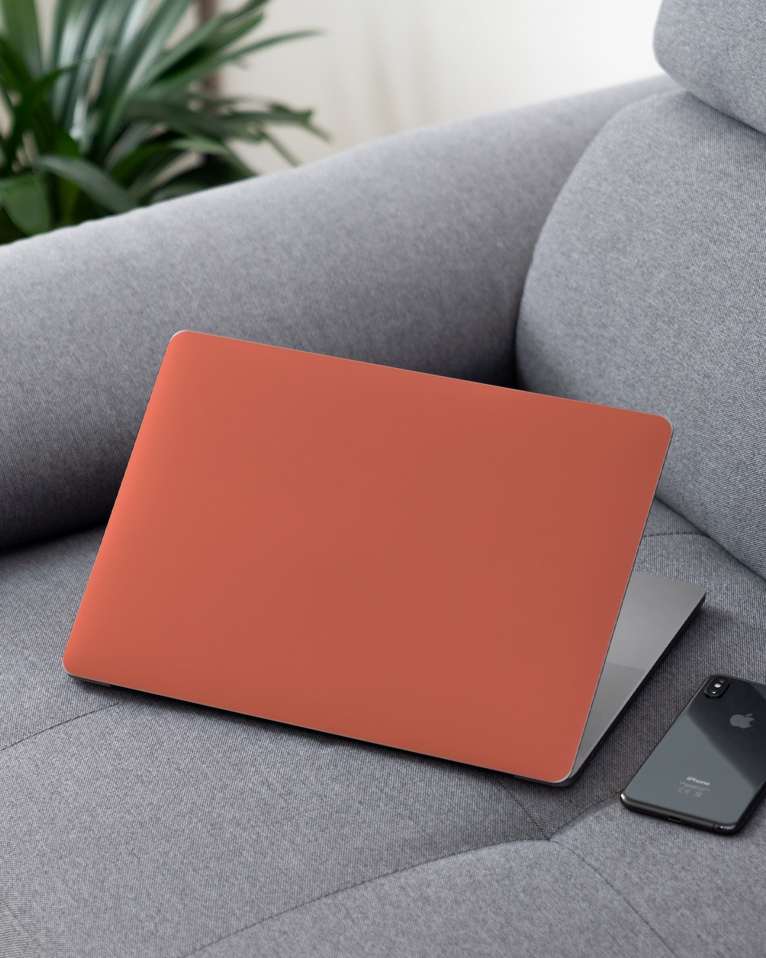 DEEP CORAL Laptop Skin for 13 inch Apple MacBooks on a couch