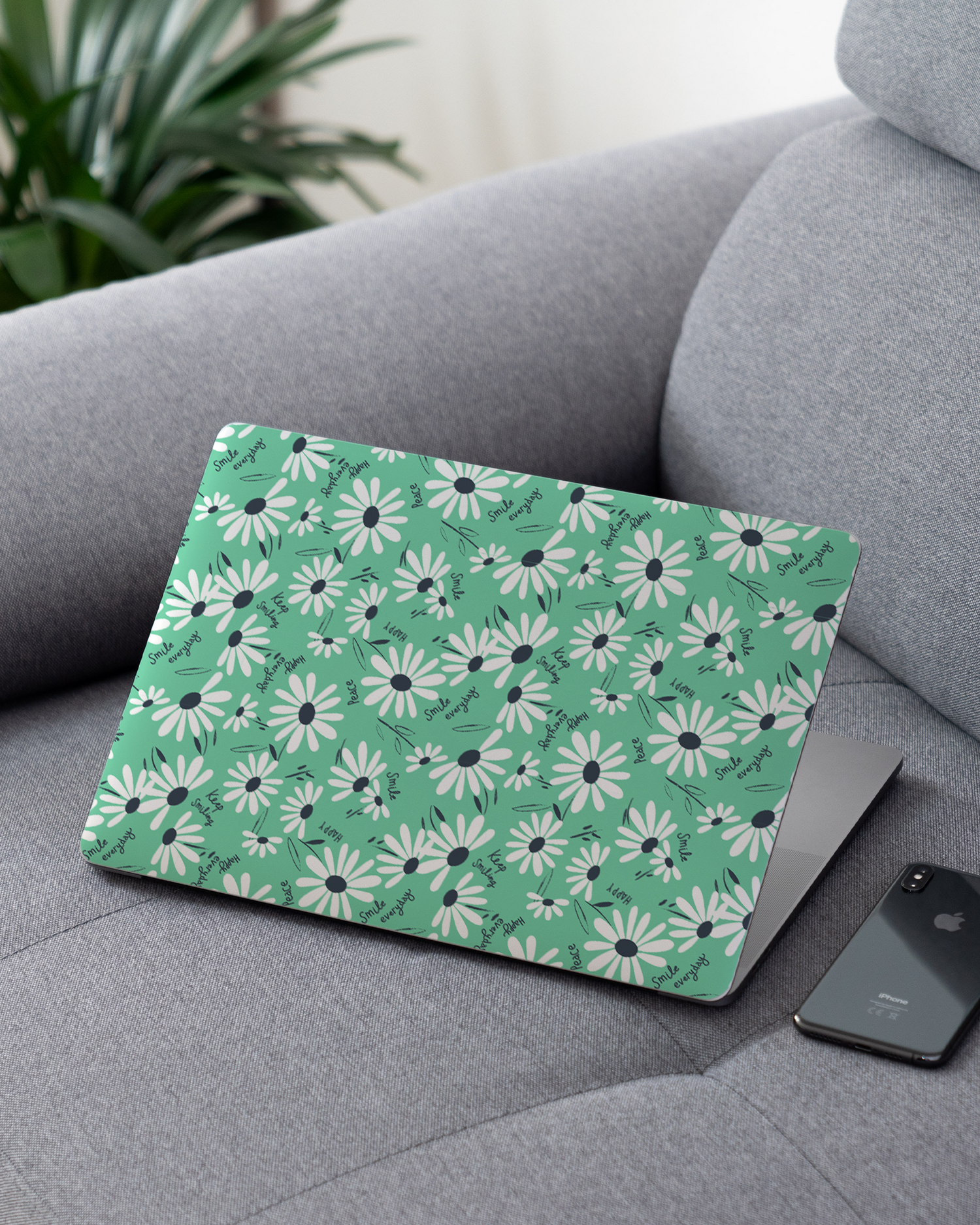 Positive Daisies Laptop Skin for 13 inch Apple MacBooks on a couch