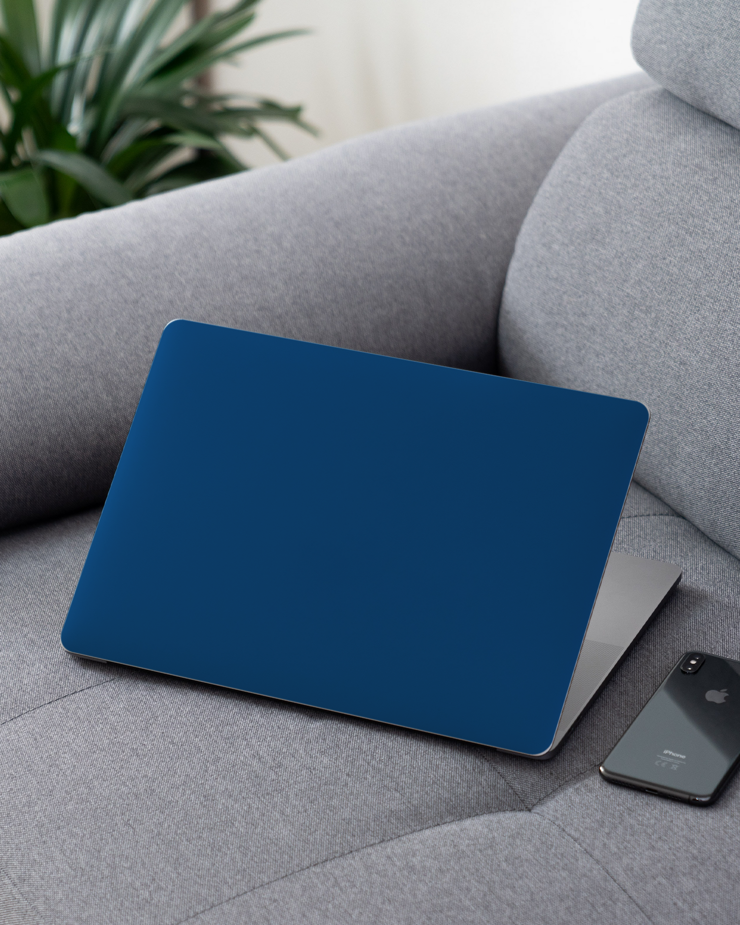 CLASSIC BLUE Laptop Skin for 13 inch Apple MacBooks on a couch